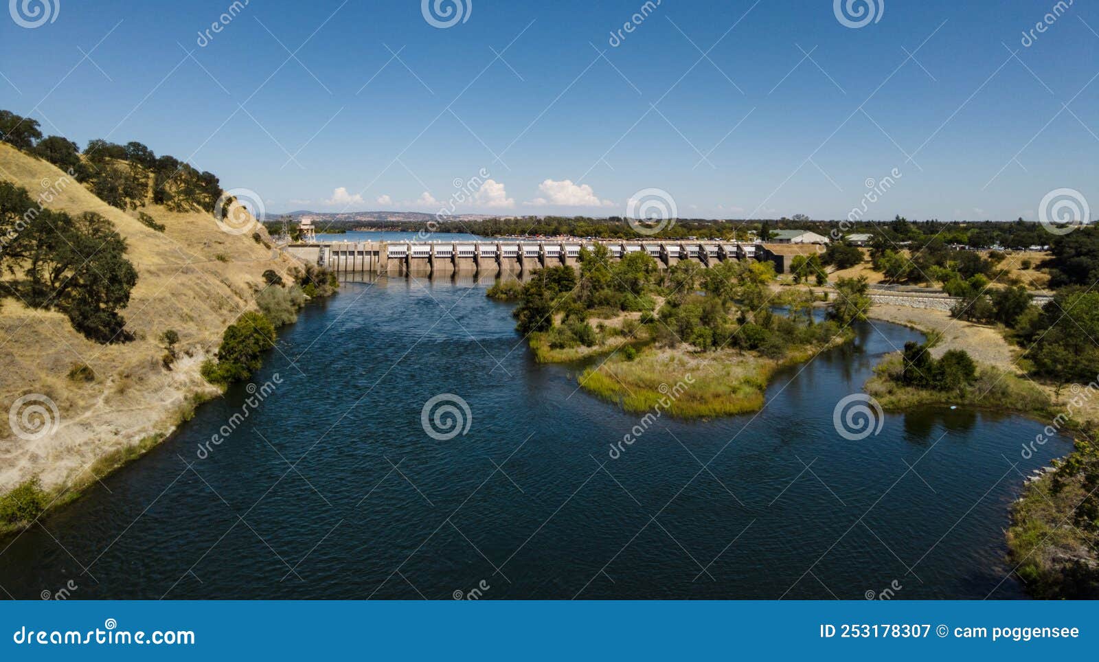 view of nimbus dam at lake natoma near sacramento in summer with a few clouds