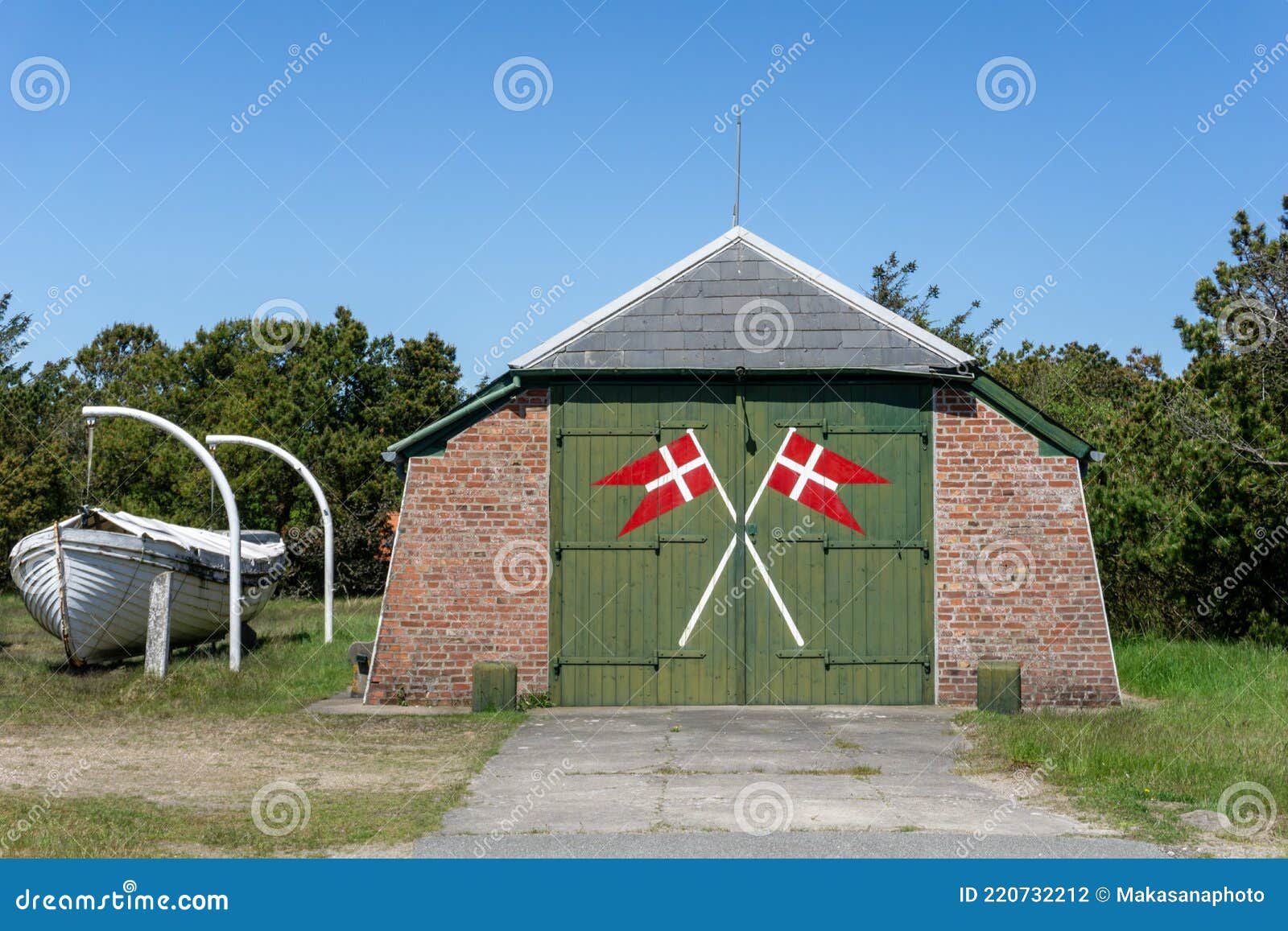 View of an Old Boathouse with the Danish Flags and a Boat Next To it