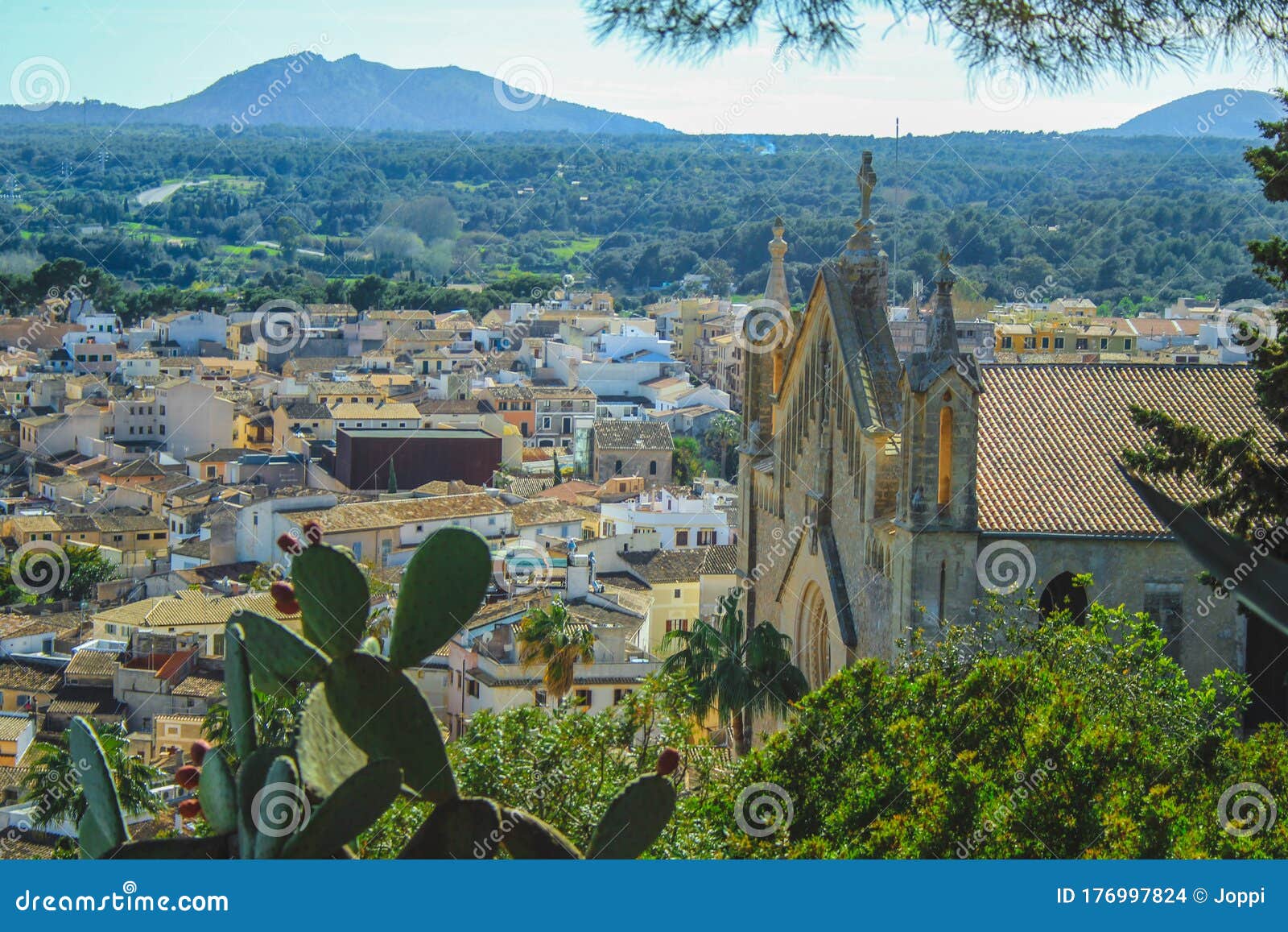 view over beautiful mediterranean village of arta - parish church of the transfiguration of the lord on the right - mallorca,