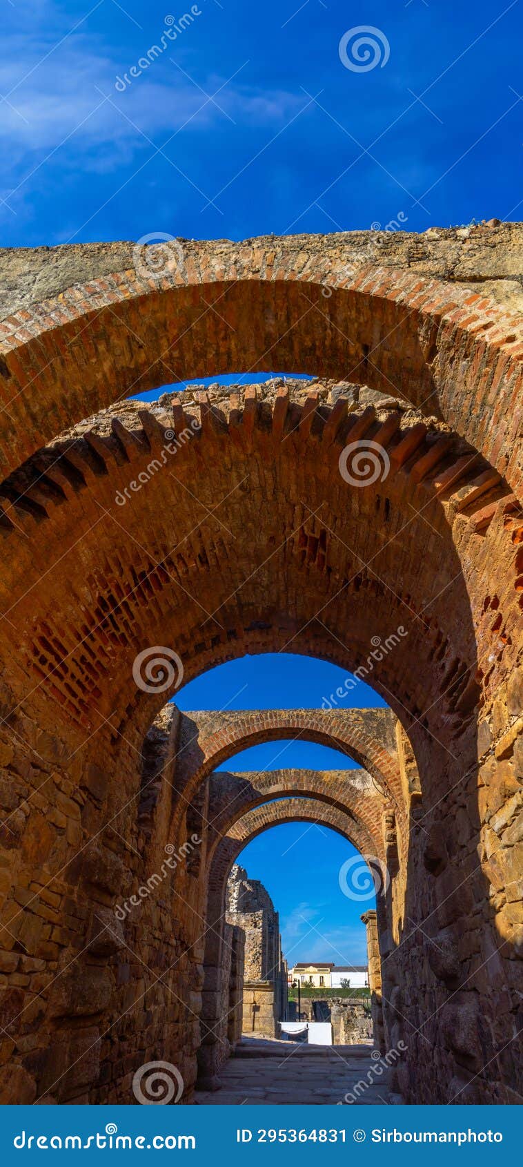 view of the restored arches of the halls of the archaeological complex of merida with the houses of the urban center of mÃÂ©rida