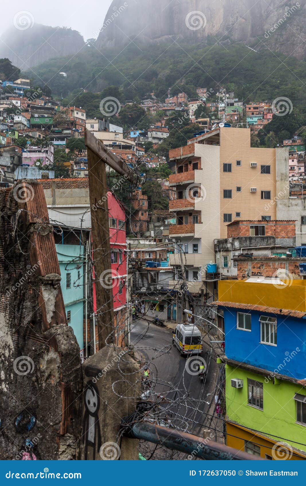 View Of Rocinha Favela With An Urban Street Running Through The Middle And Slums And Mountain In Background In Rio De Janeiro Stock Photo Image Of Favela Landmark