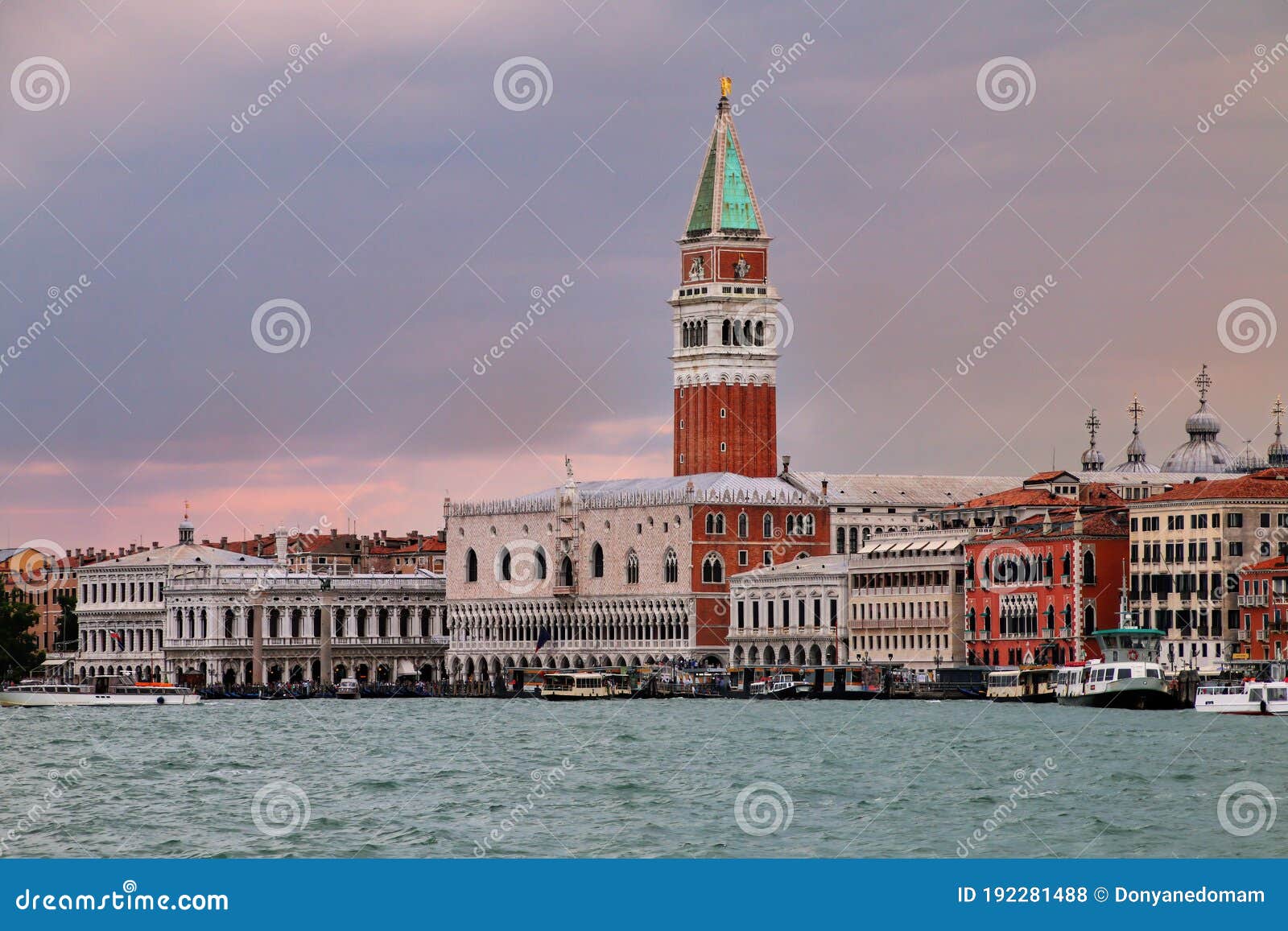 view of san marco campanile, palazzo ducale and biblioteca at sunset in venice, italy