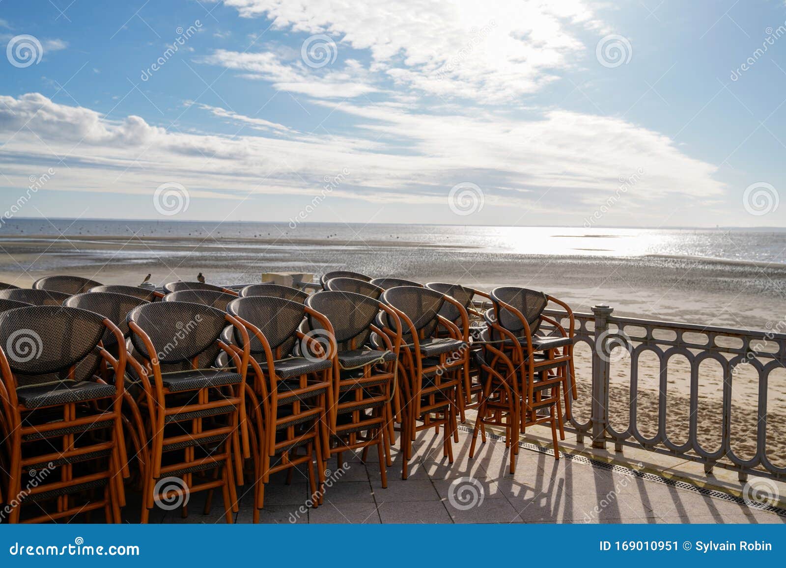 view sea beach andernos-les-bains in arcachon bay cafe terrace seat in pontoon at low tide
