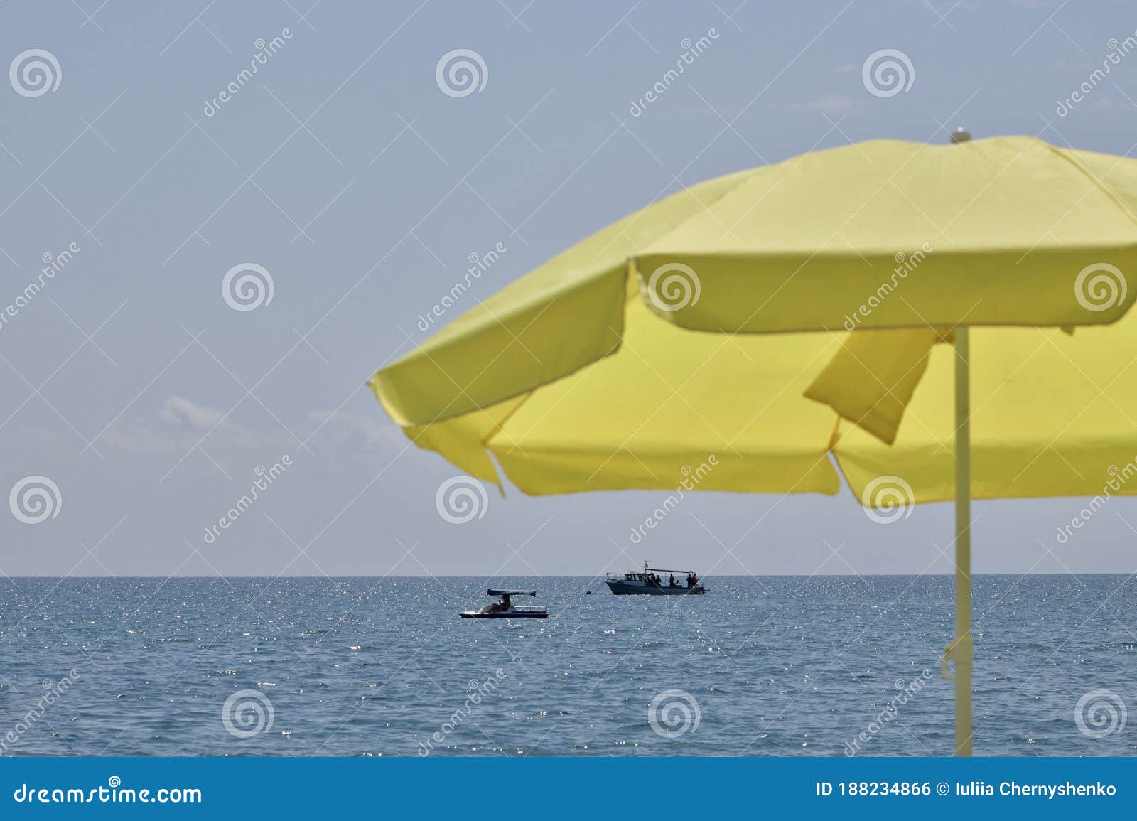 Yellow Sun Umbrella, Blue Sky and Blue Sea with Boats. Stock Photo ...