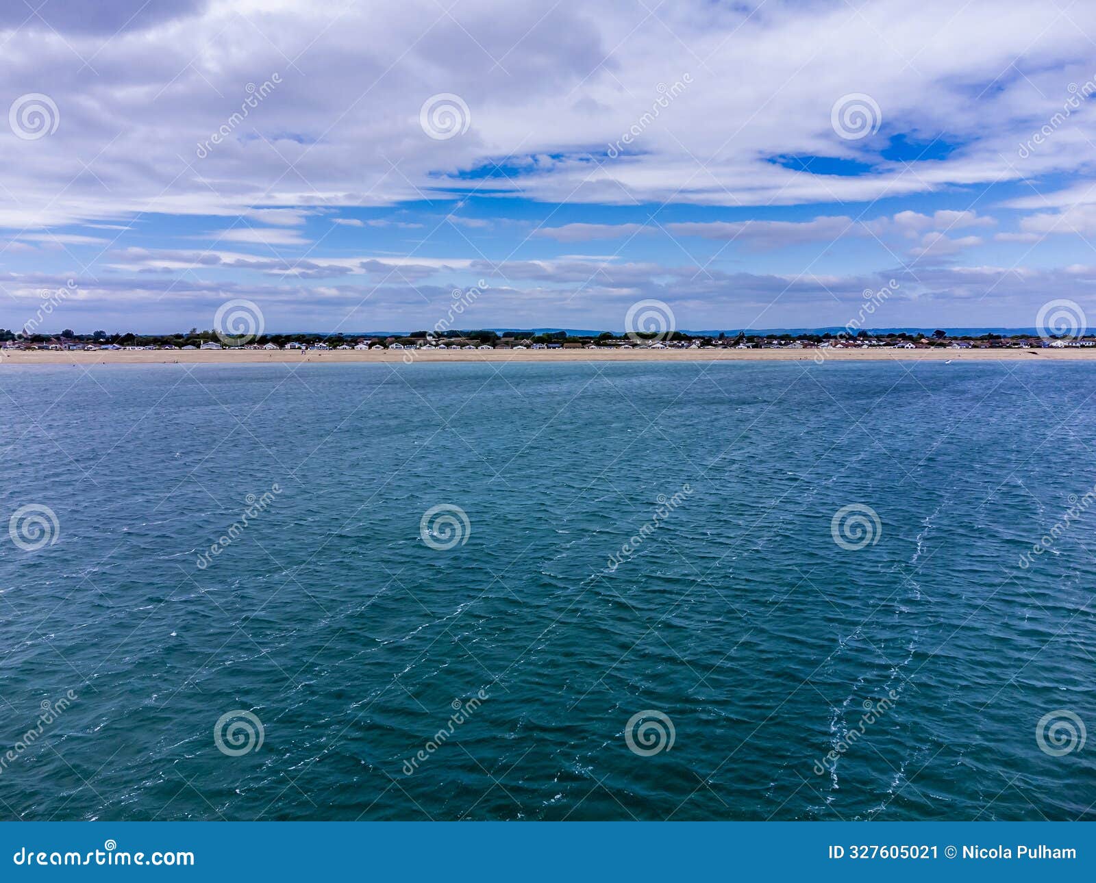 a view from the sea towards the beach at pagham, sussex