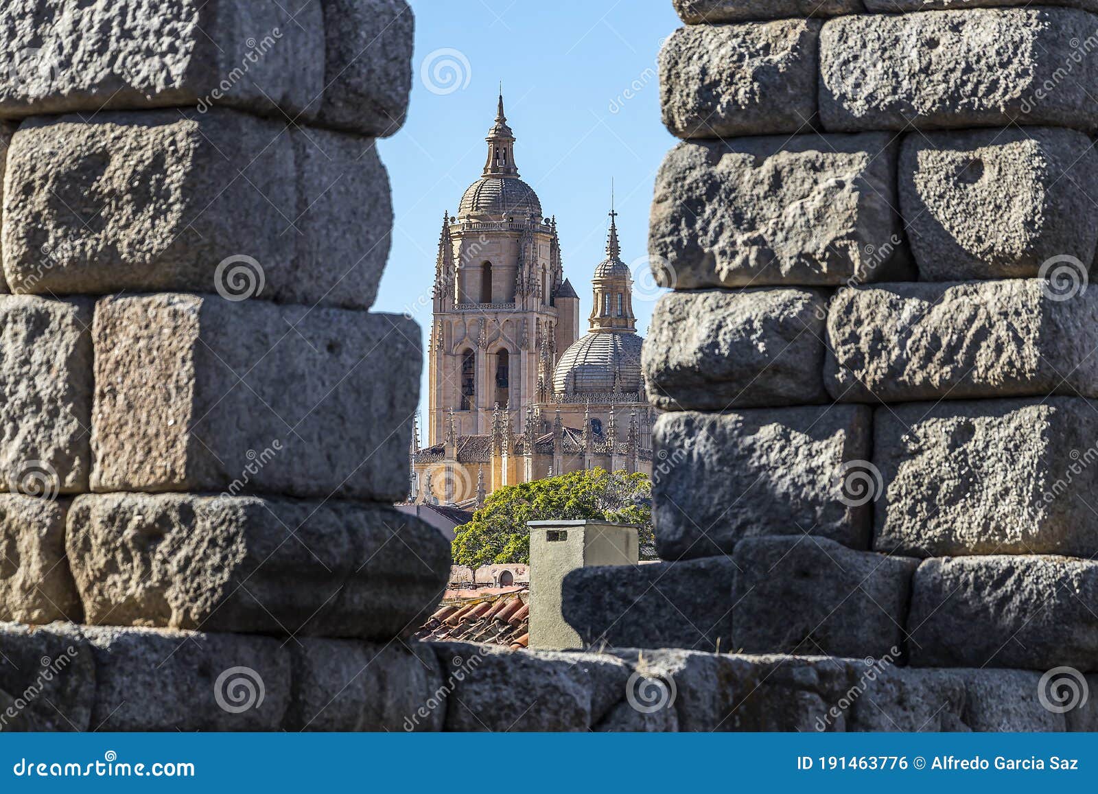view of segovia cathedral through an aqueduct arch, in autonomous region of castile and leÃÂ³n.  declared world heritage sites by