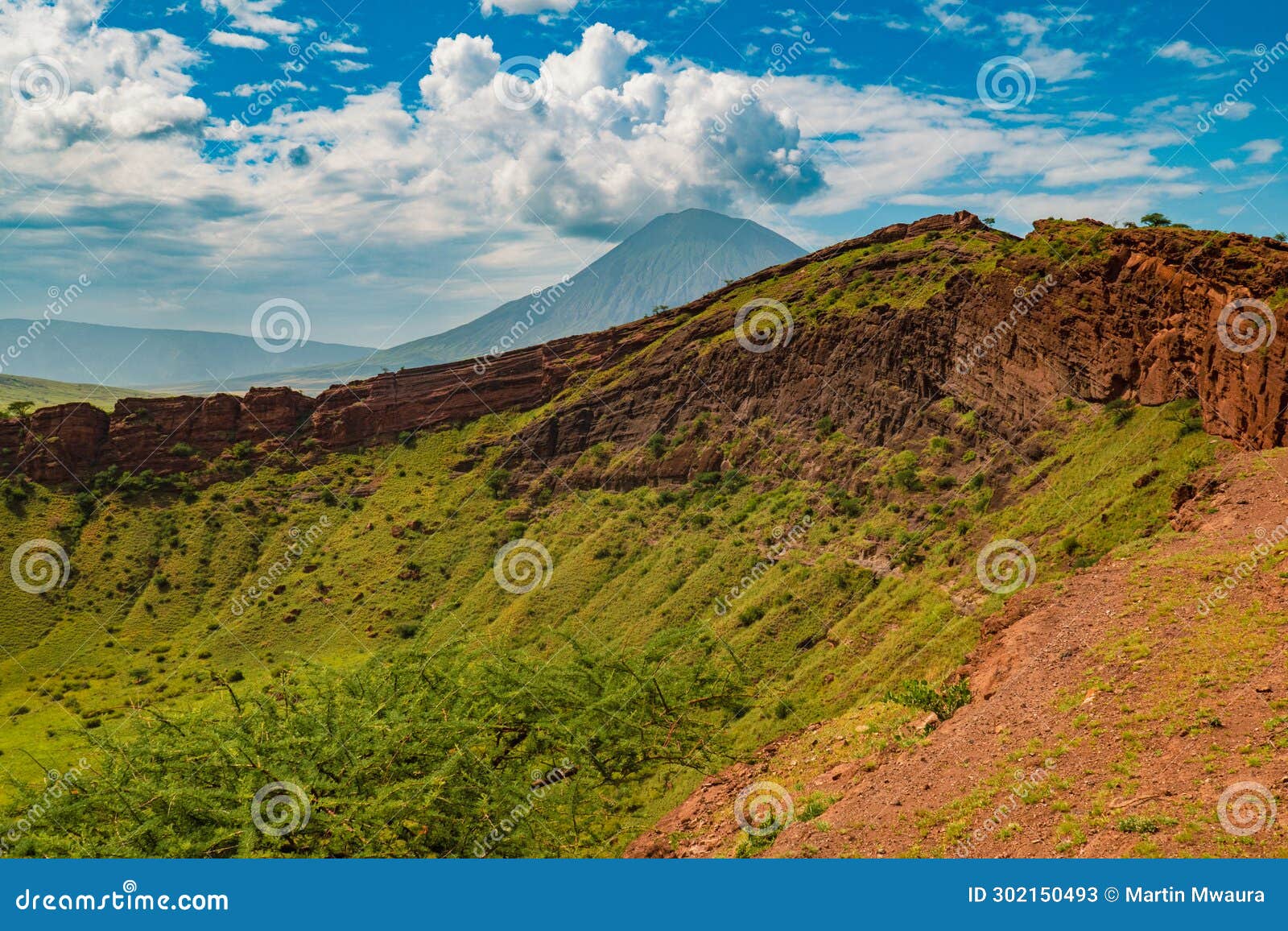 view of shimo la mungu - pit of god on the edge of the makonde plateau with mount ol doinyo lengai in the background, tanzania