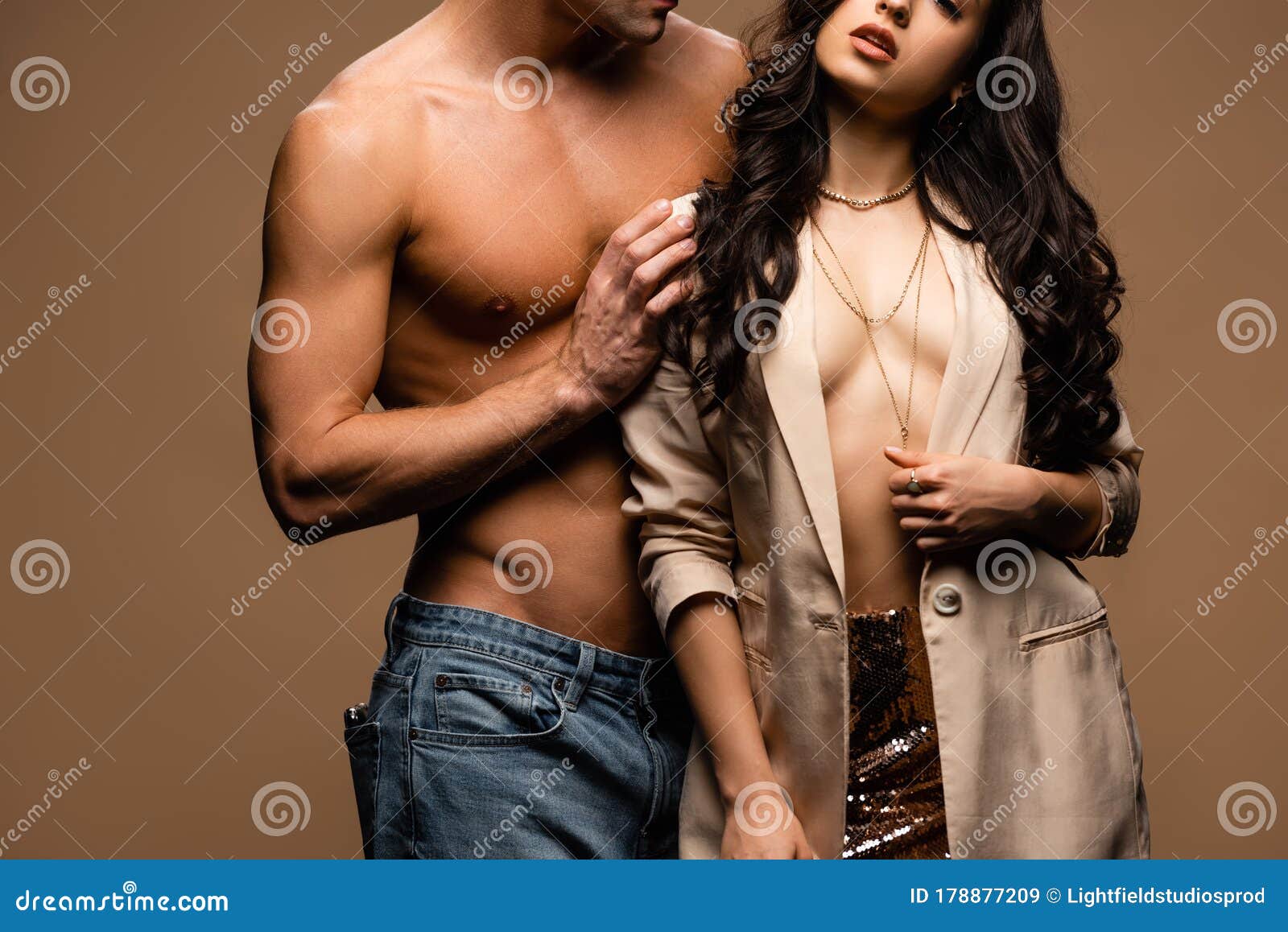 View of Shirtless Boyfriend Hugging Half Naked Girlfriend in Beige Jacket Isolated on Beige Stock Image picture