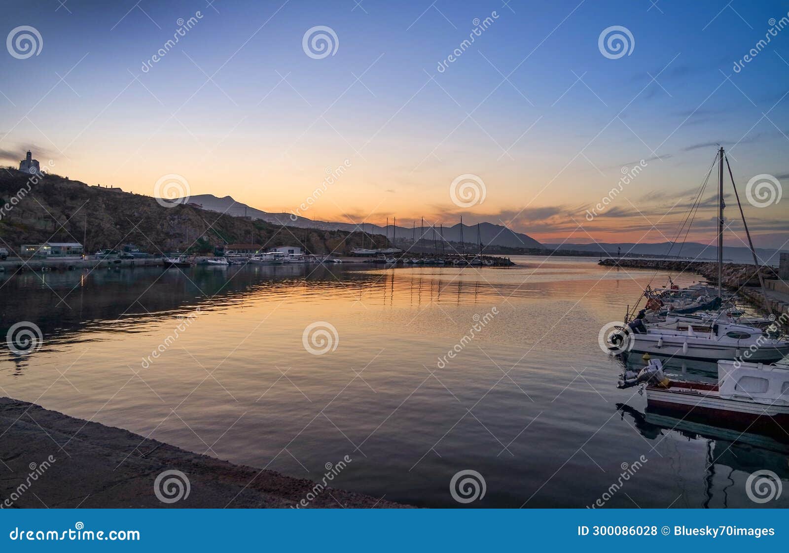 view of small fishing harbour in rafina city at sunset .greece