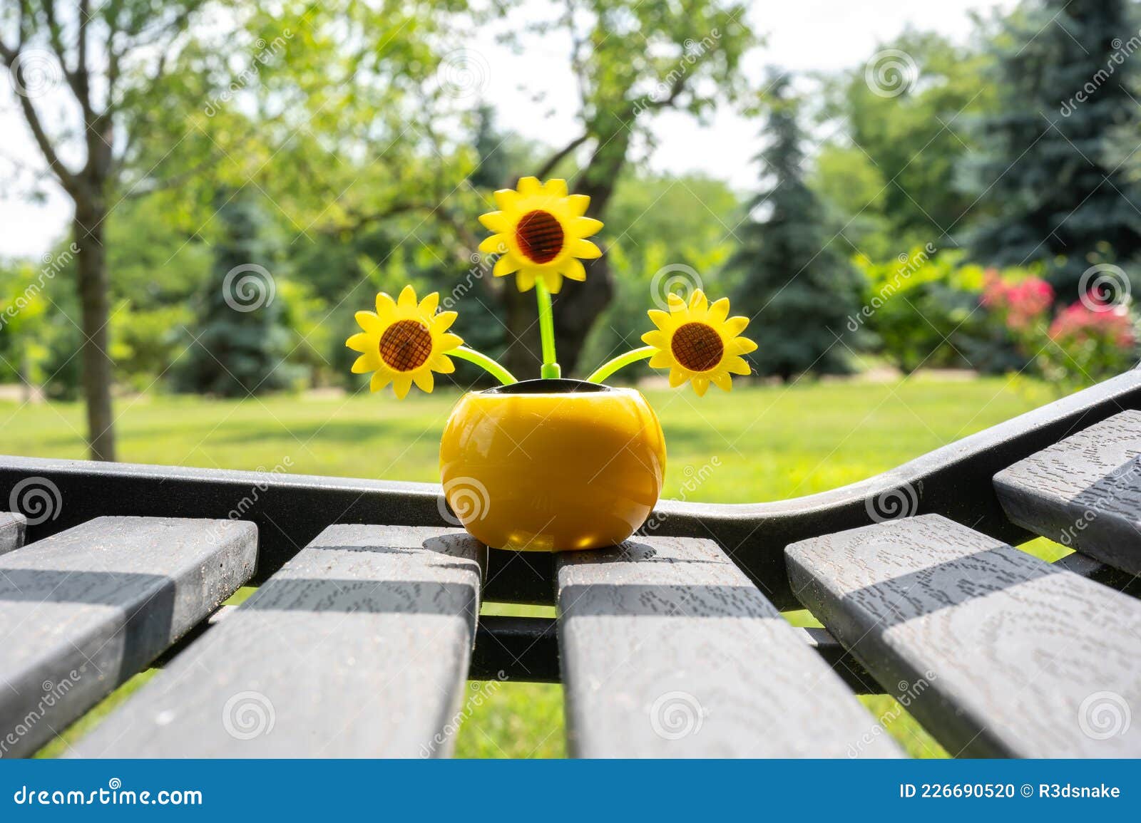 View on a Solar Powered Plastic Artificial Sunflower Moving by the