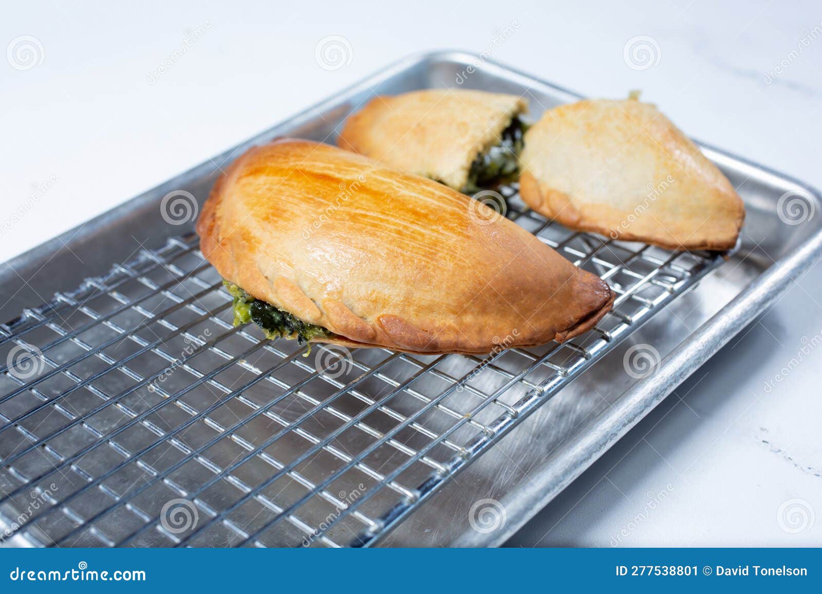 Spinach empanada on tray stock image. Image of food 277538801