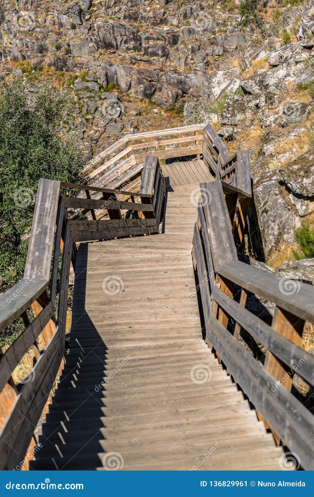 view of a stairs on wooden suspended pedestrian walkway on mountains, overlooking the paiva river