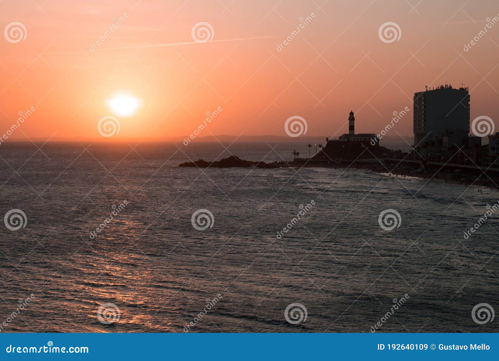 view of the sunset on the beach bar with the barra lighthouse in the background