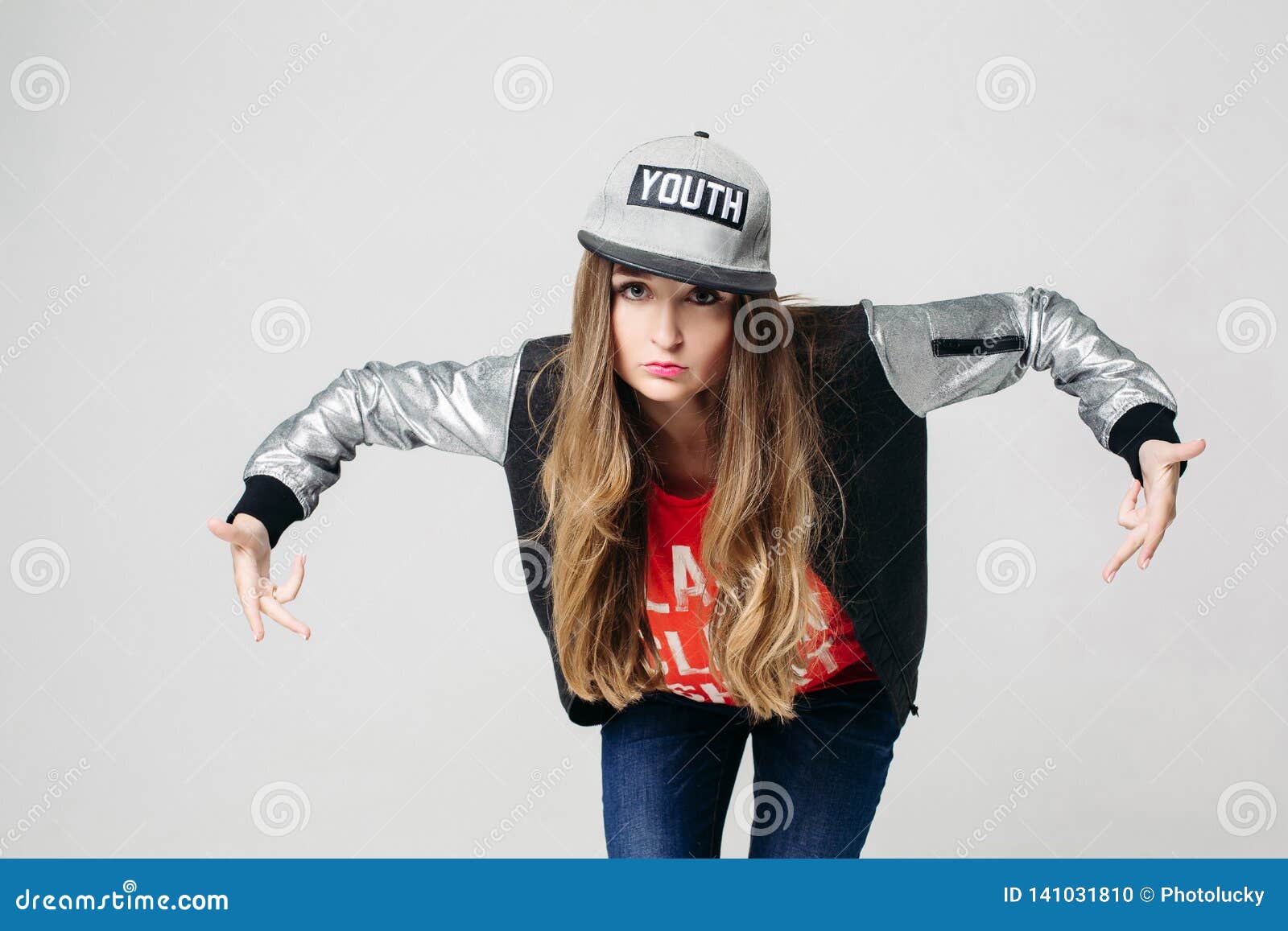 Modern Girl Wearing Casual Clothes And A Cap Posing Outdoor