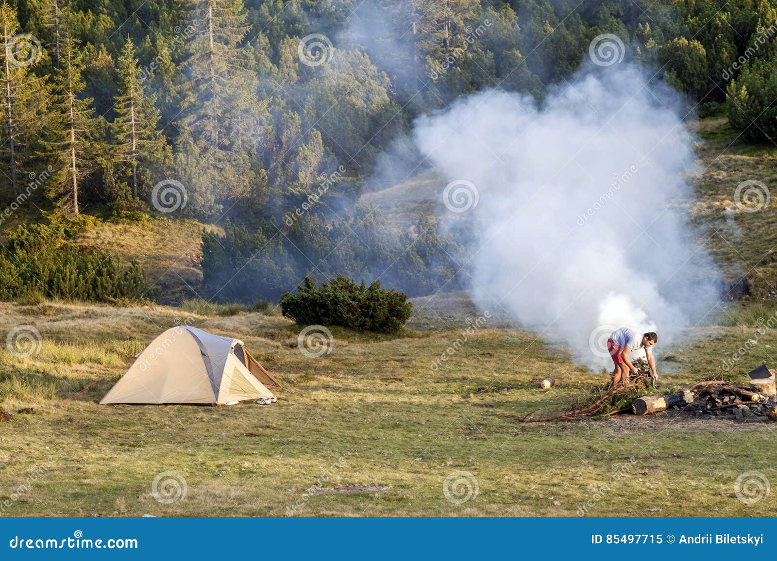 View with a Tent, Camping Fire Wit Smoke and Tourist Hiker in Summer Day. Stock - Image of firewood, happy: 85497715