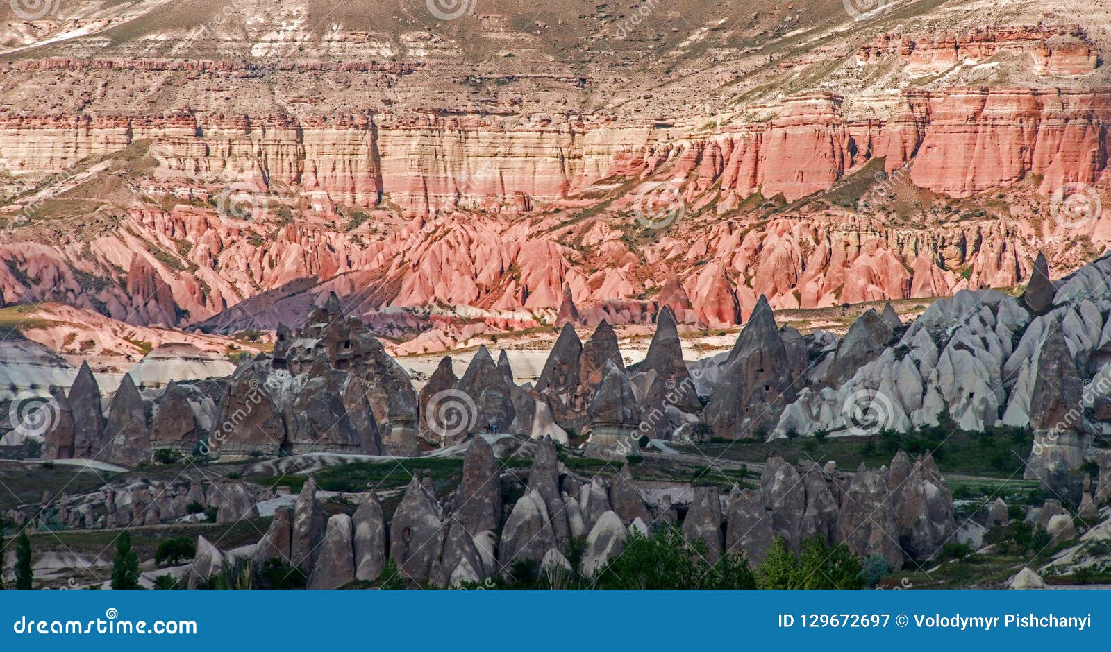 view to geological formations in cappadocia, turkey. ancient cavetown near goreme on the sunset