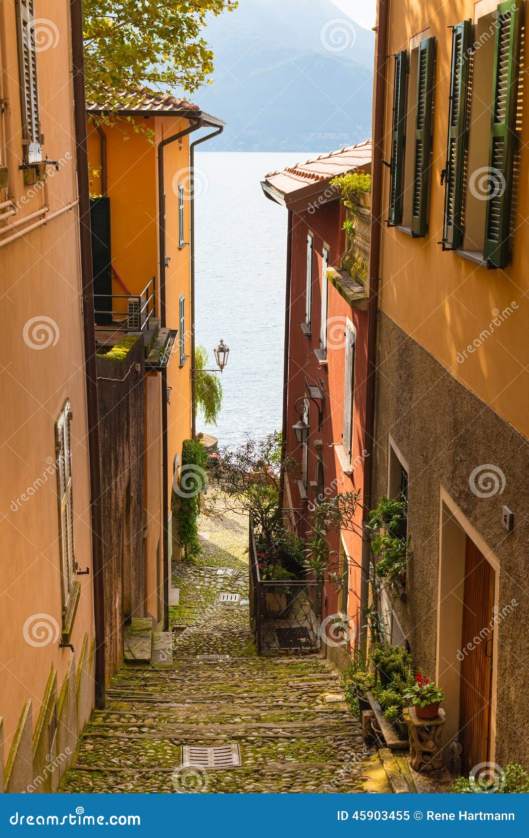 view to the italian lake como from one of the narrow streets.