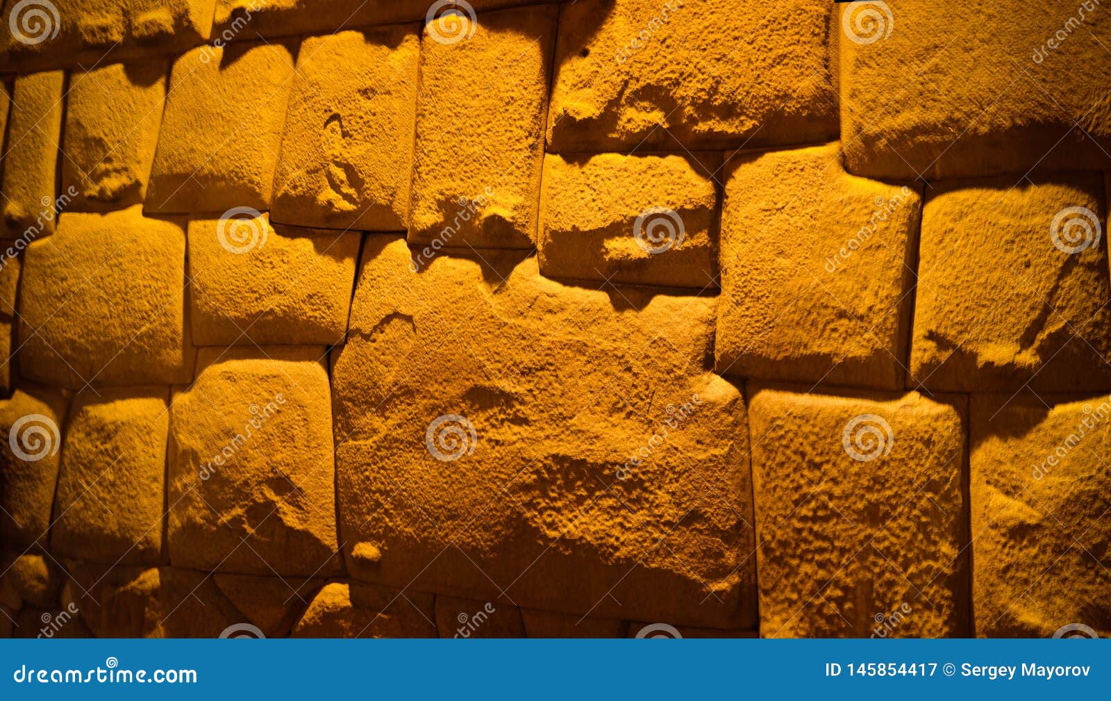 view to twelve-angled stone aka hatun rumiyoc as a part of a wall of the palace of the archbishop of cuzco, peru