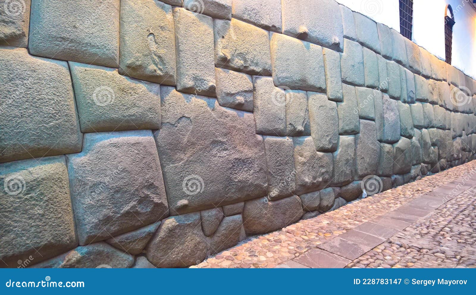 view to twelve-angled stone aka hatun rumiyoc as a part of a wall of the palace of the archbishop of cuzco, peru