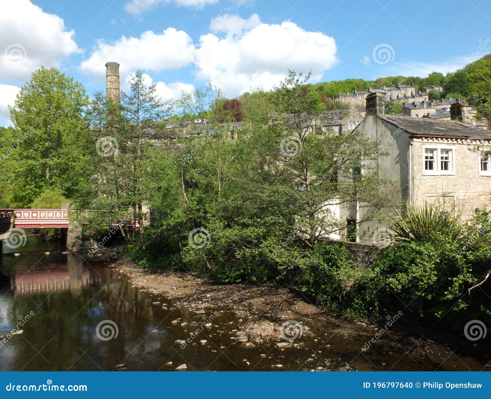 View of the Town of Hebden Bridge with the River and Bridge Surrounded by Summer Trees Stock