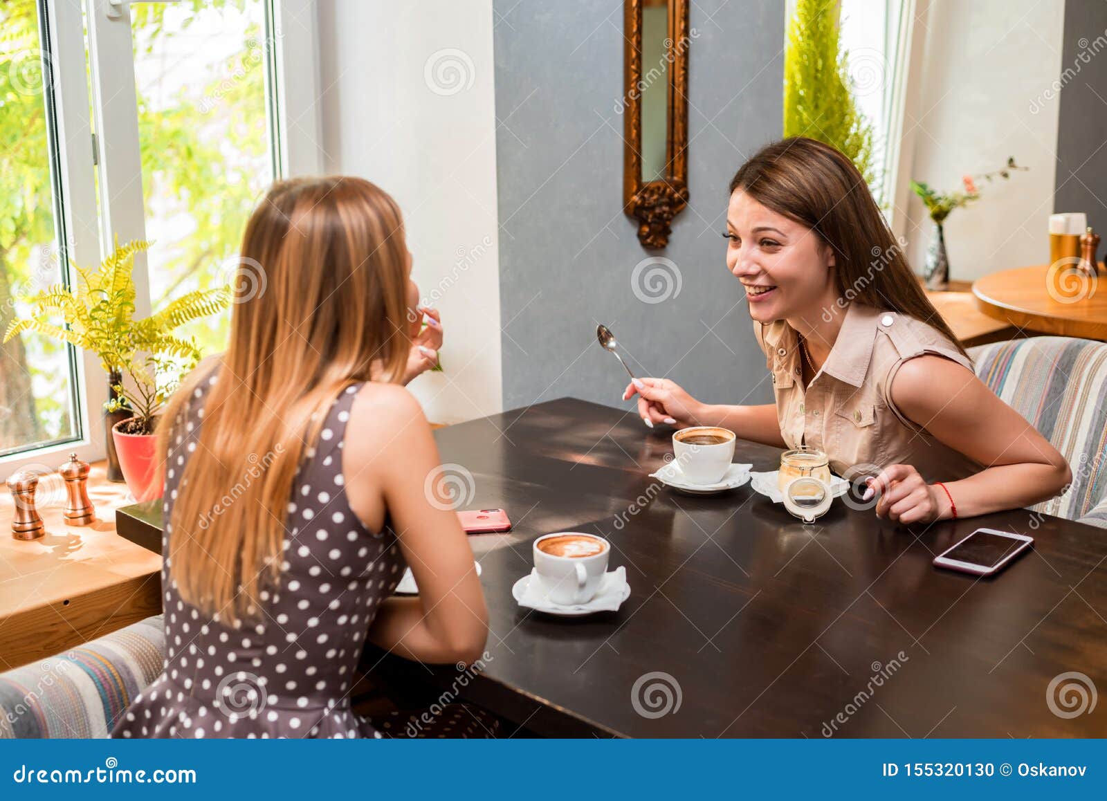 Two Happy Smiling Girl Friends Have Coffee and Dessert in Modern ...