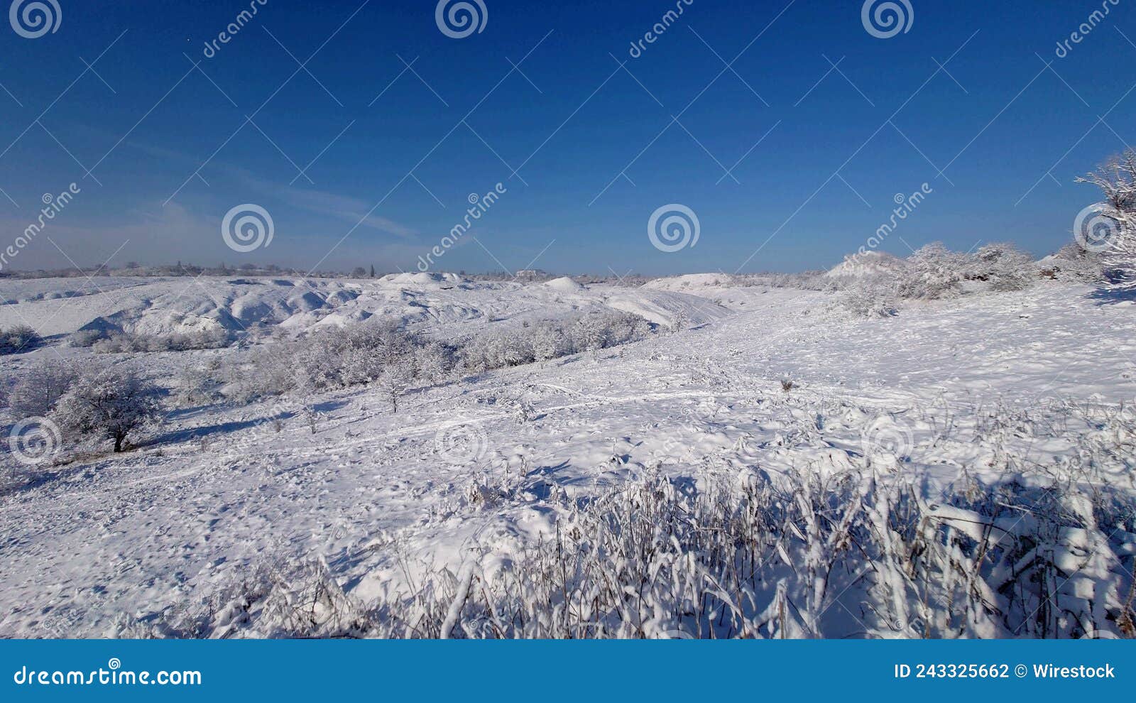 view of waste heaps covered in snow under a blue sky in donbas, ukraine