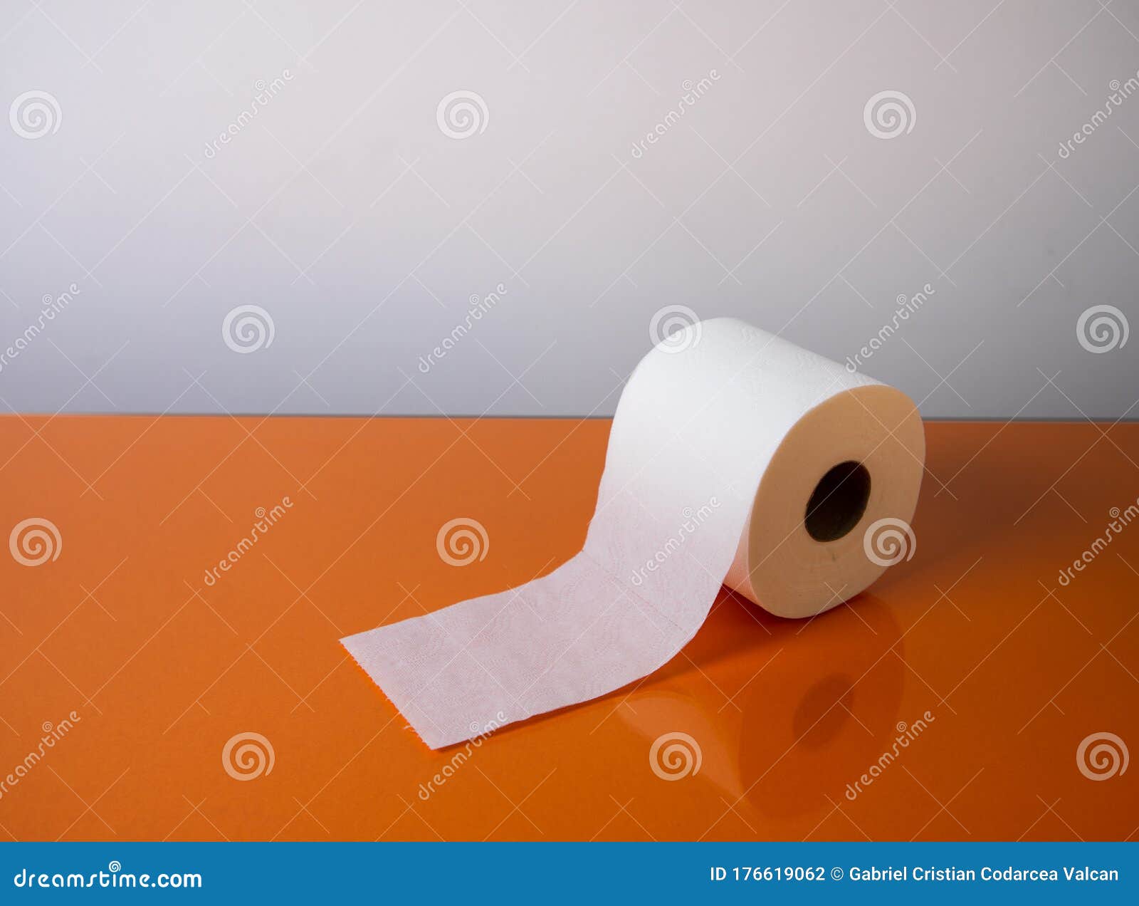 view of a white toilet paper roll over an orange background