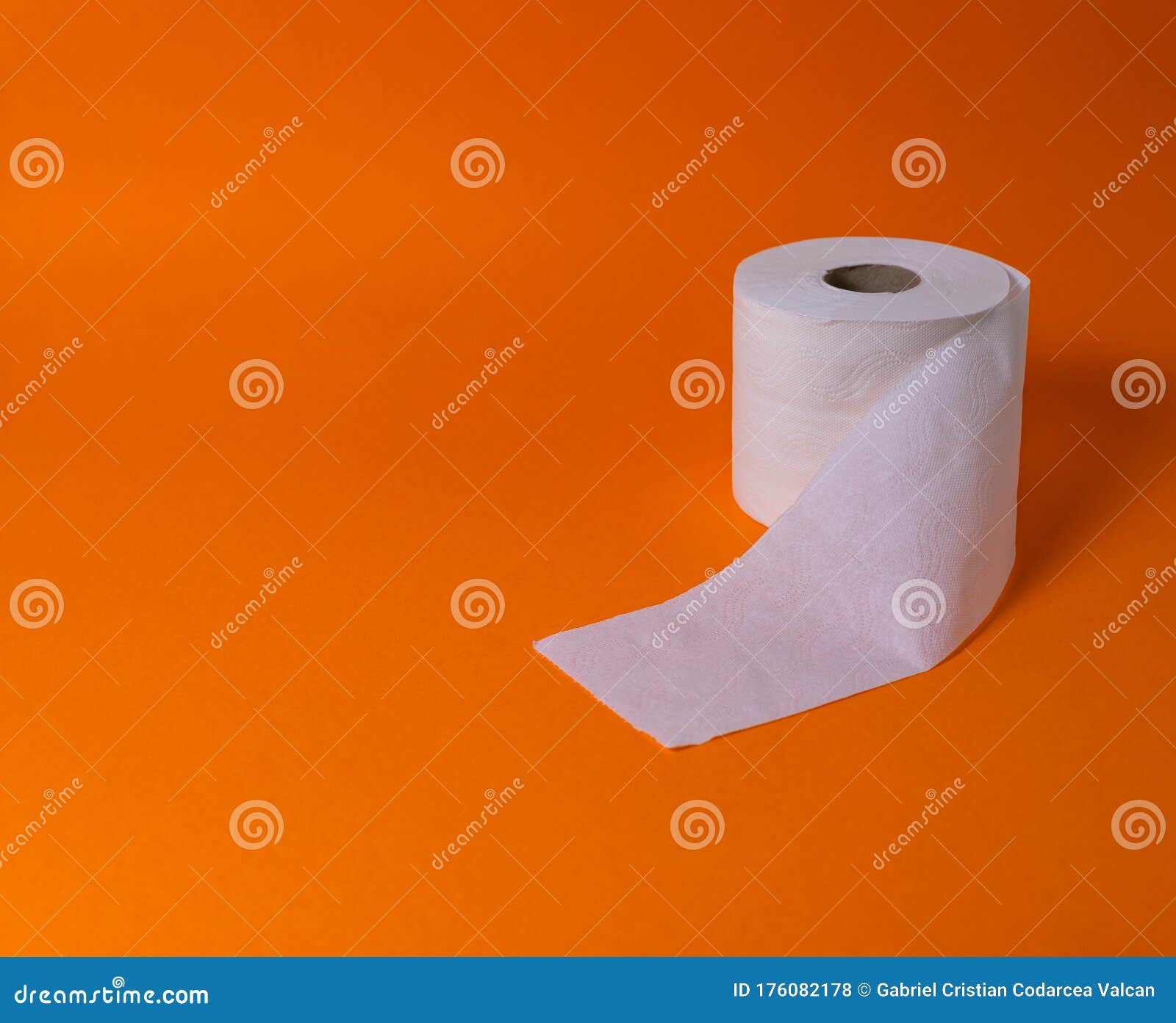 view of a white toilet paper roll over an orange background
