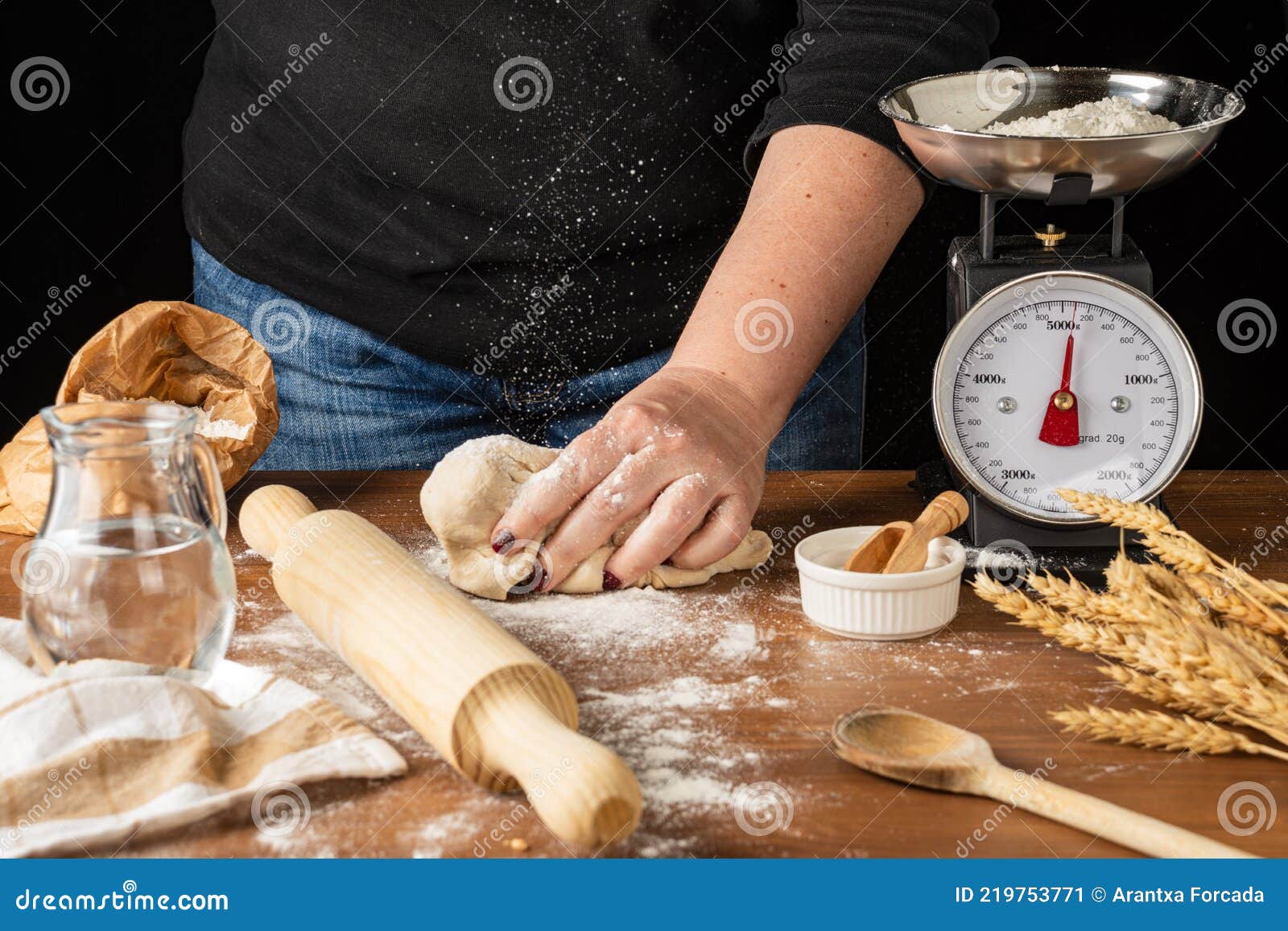 View of Woman`s Hand on Pizza Dough, Falling Flour, on Wooden Table