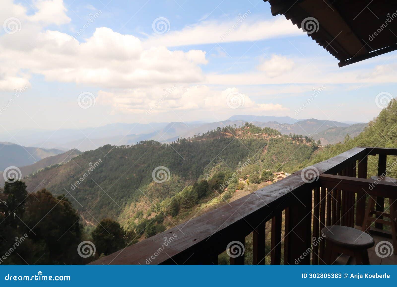 view from a wooden balcony onto the hilly landscape of san jose del pacifico, oaxaca, mexico