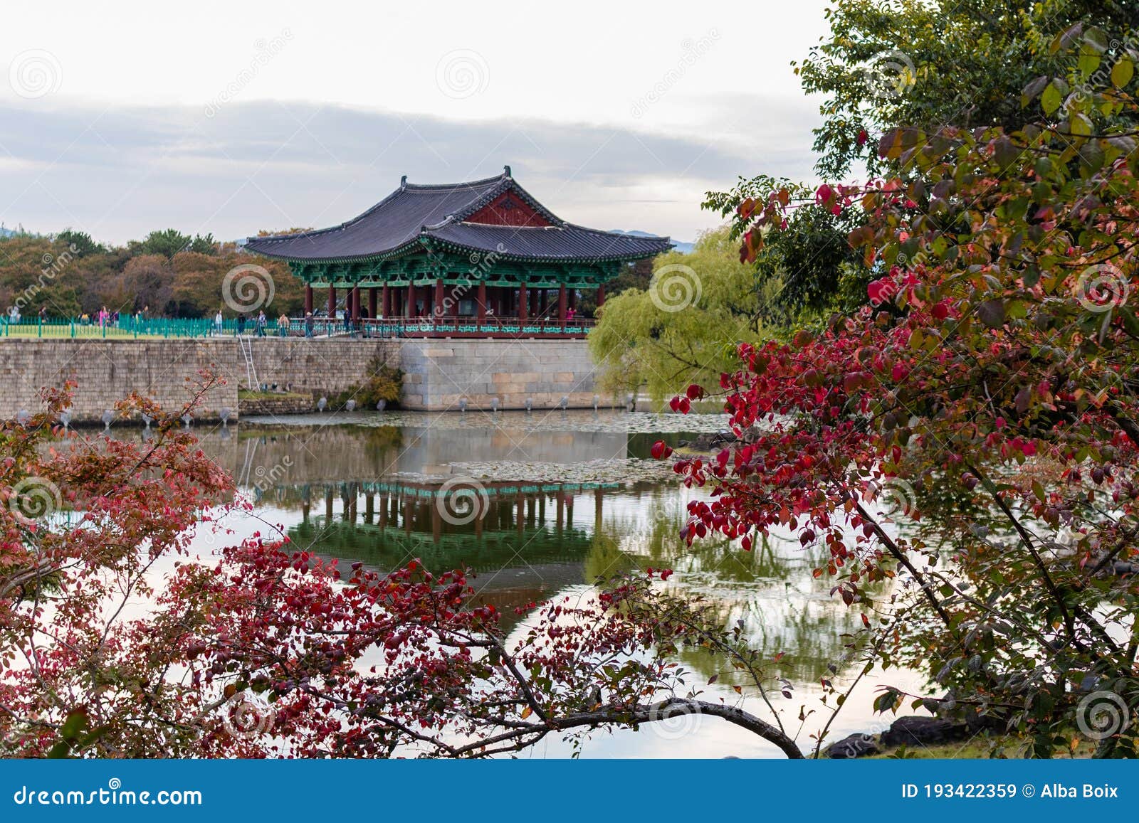 views of donggung palace reflected at the lake surrounded by colorful trees in autumn. traditional korean ancient roof, held by
