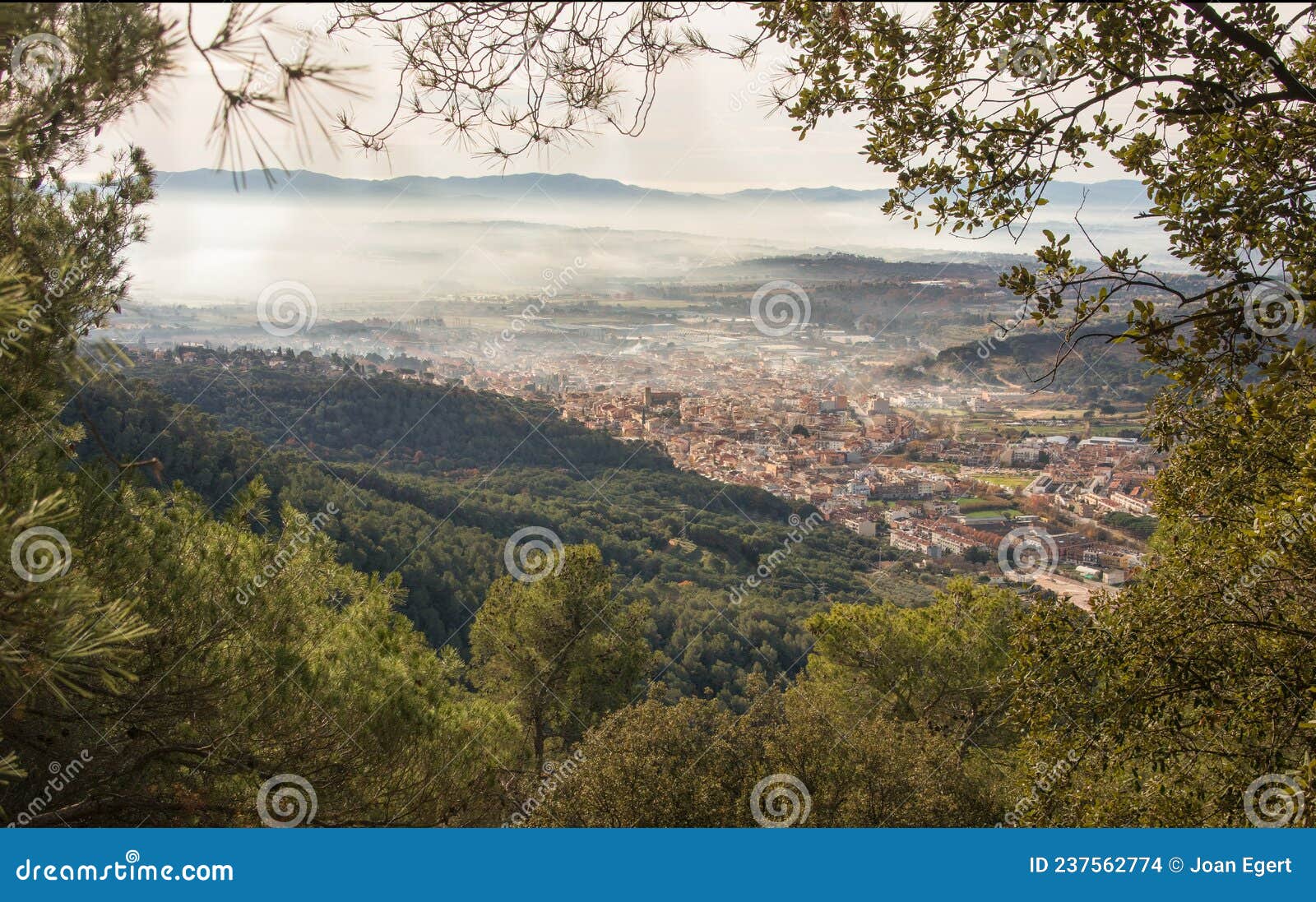 views to the village of la garriga through the forest