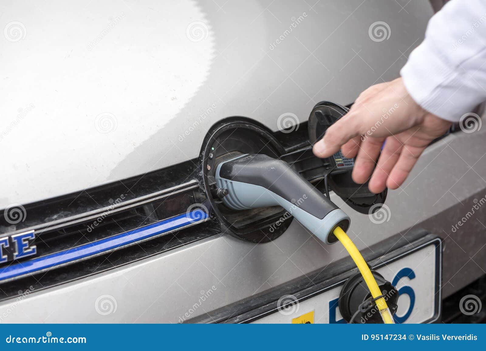 Charging an Electric Car with the Power Cable Supply Plugged in