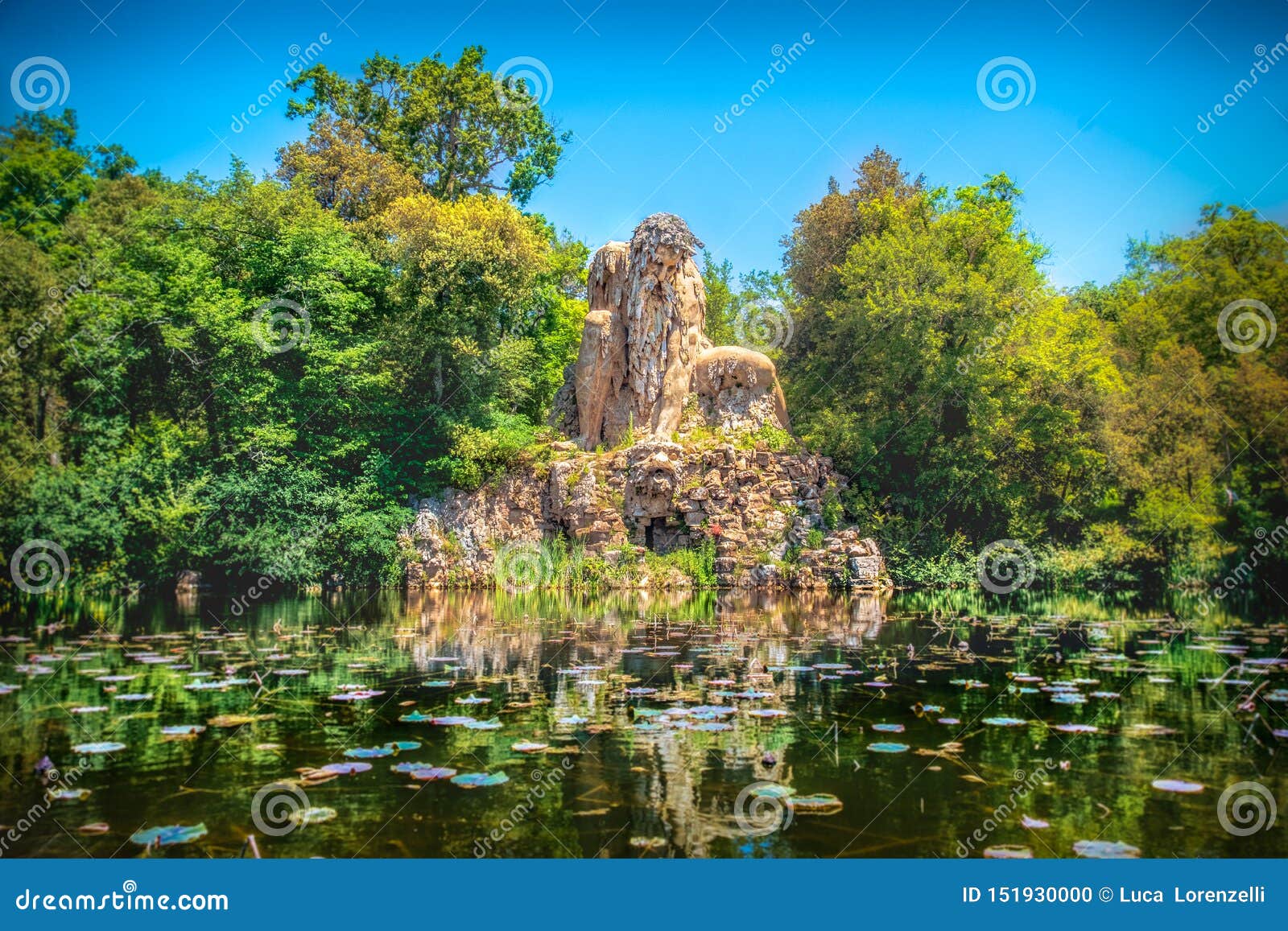 villa demidoff pratolino park and the colosso del appennino colossus statue with pond full of waterlilies and leaves