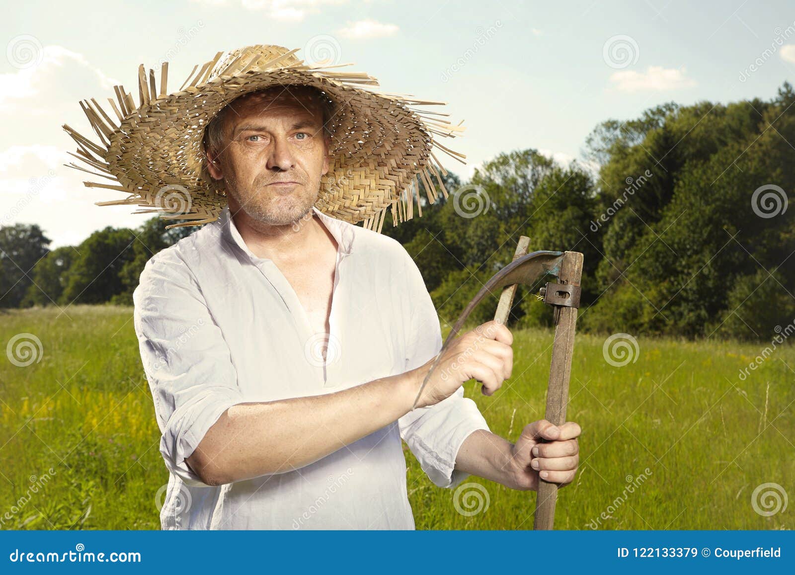 Country Man in Straw Hat Mowing Grass in Sunny Day Stock Image