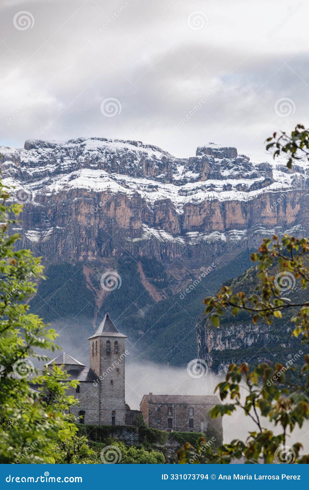 village of torla with the snowy pyrenees in the background.