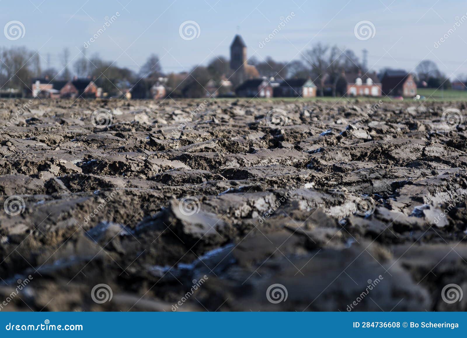 village view of godlinze, with plowed clay soil in the foreground.