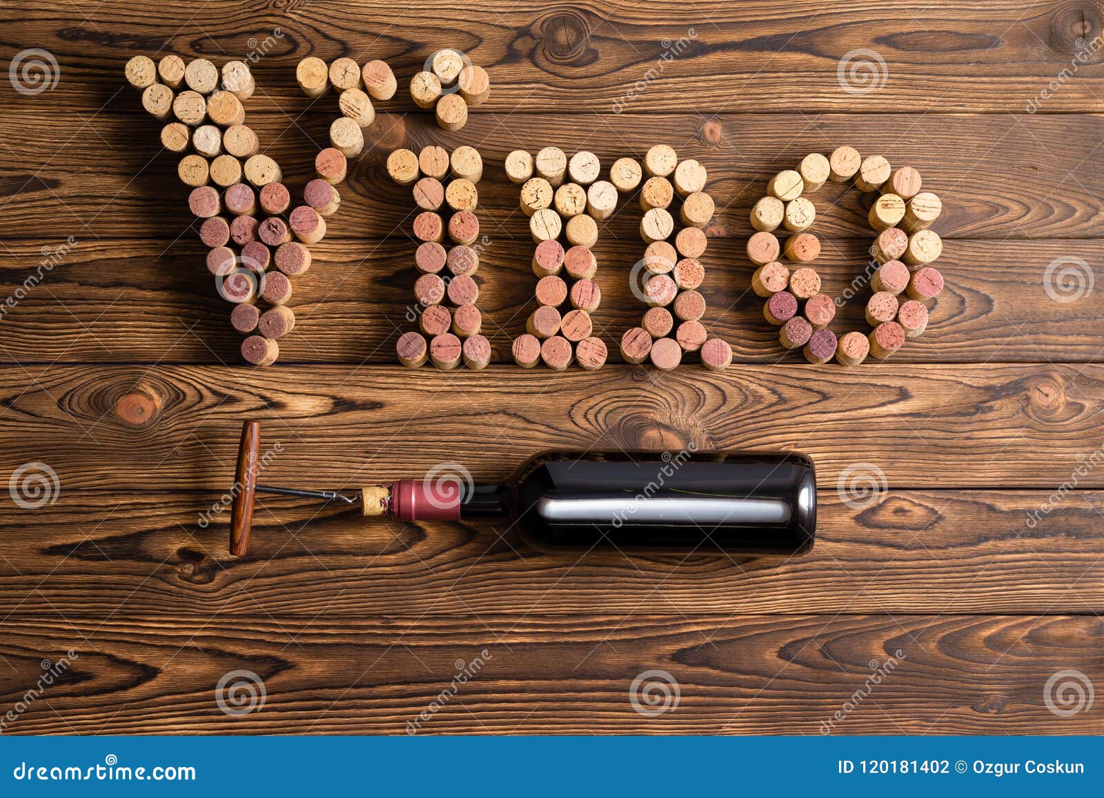 vino lettering with bottle of wine on wood