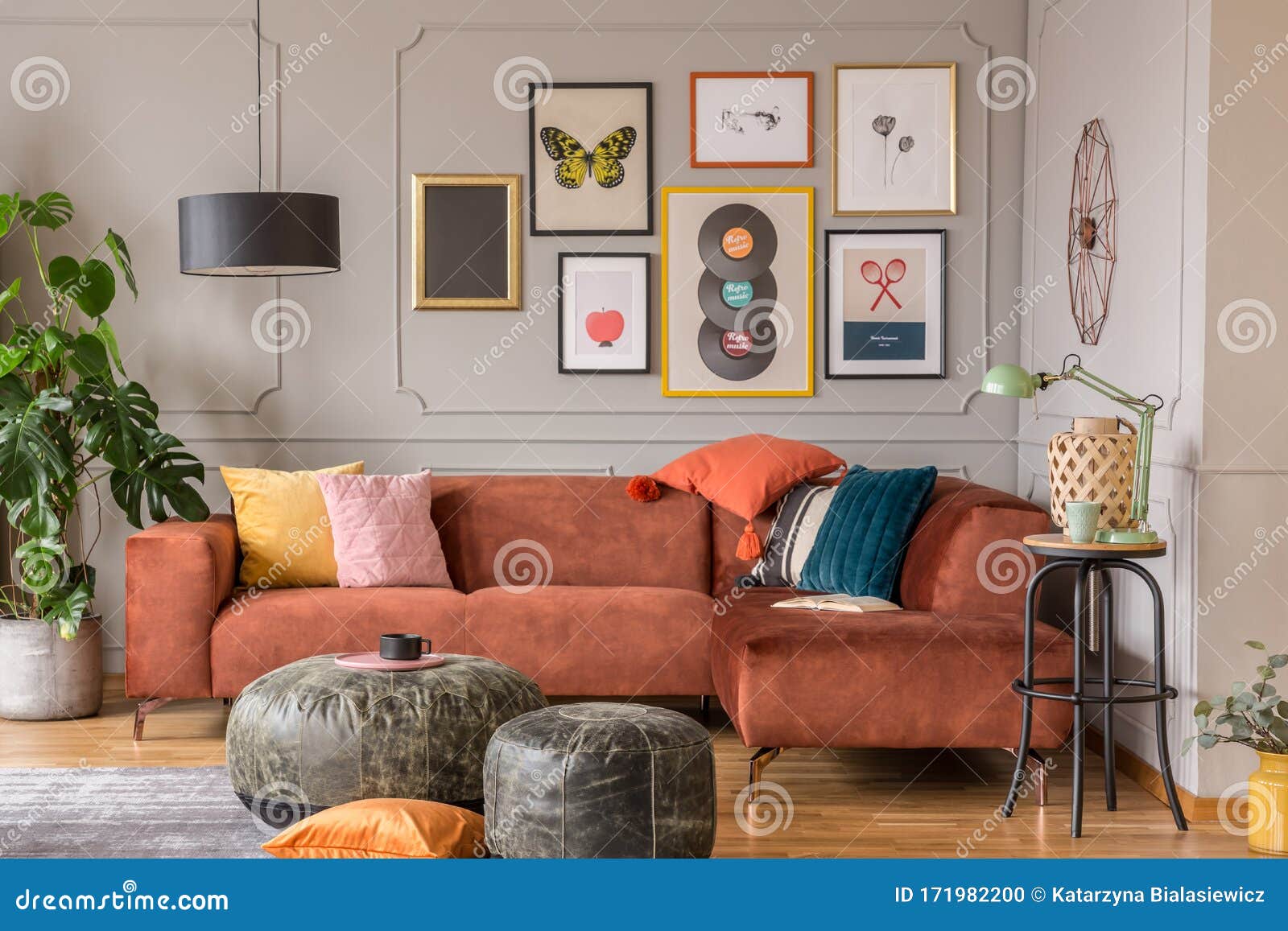 vintage black poufs in trendy eclectic living room interior with brown couch