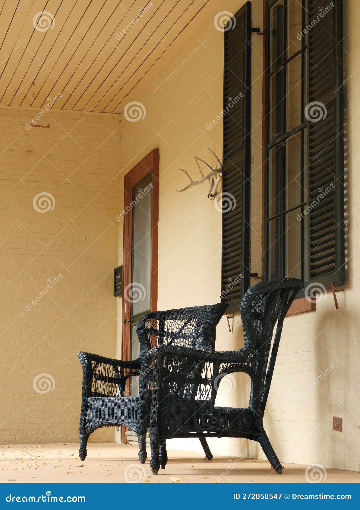 Vintage Black Wicker Chairs on Historic Brick Lorenzo Mansion Stock