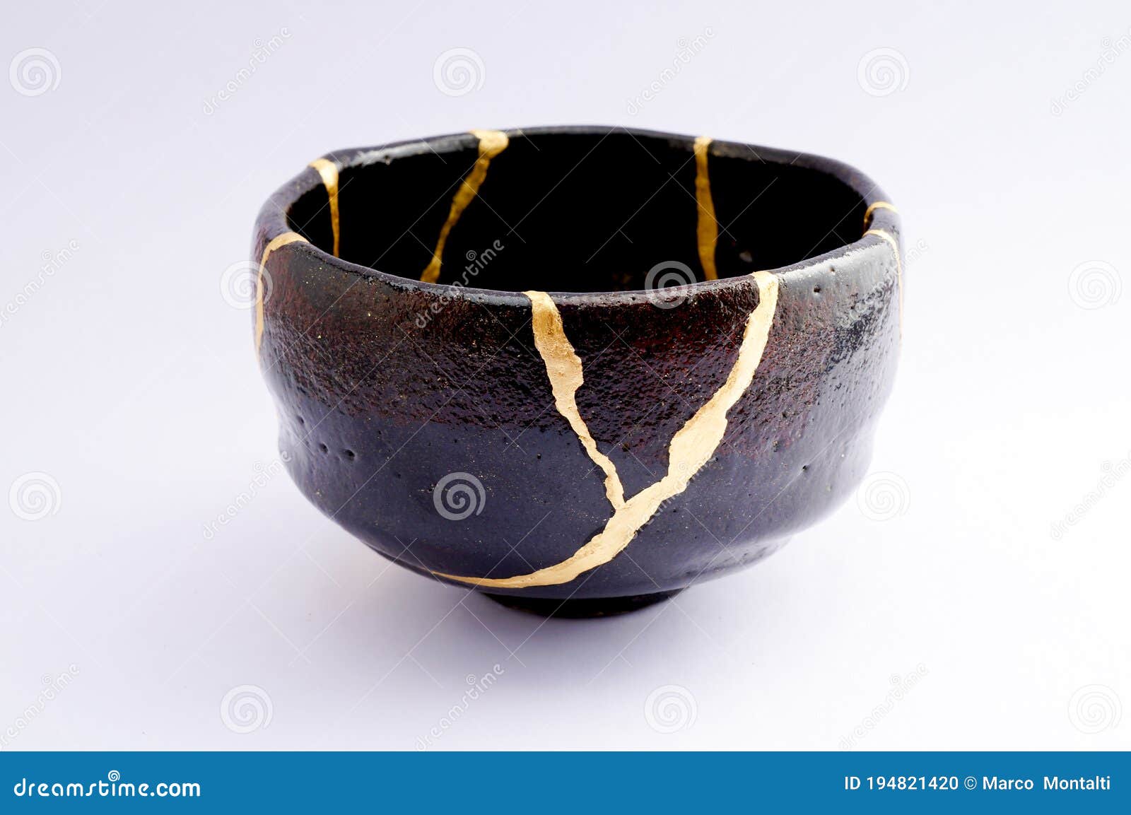 vintage broken black tea ceremony bowl repaired with gold kintsugi technique
