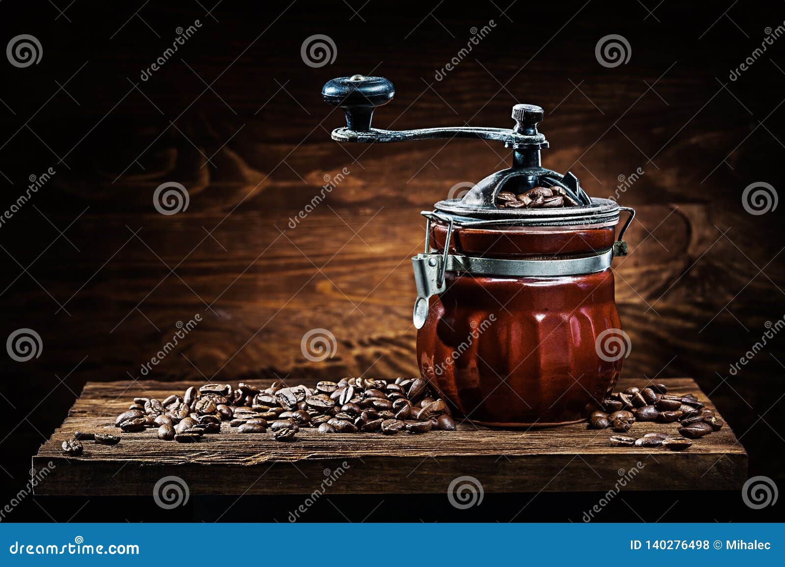 Vintage Ceramic Coffee Mill with Beans on Wood Board Stock Photo