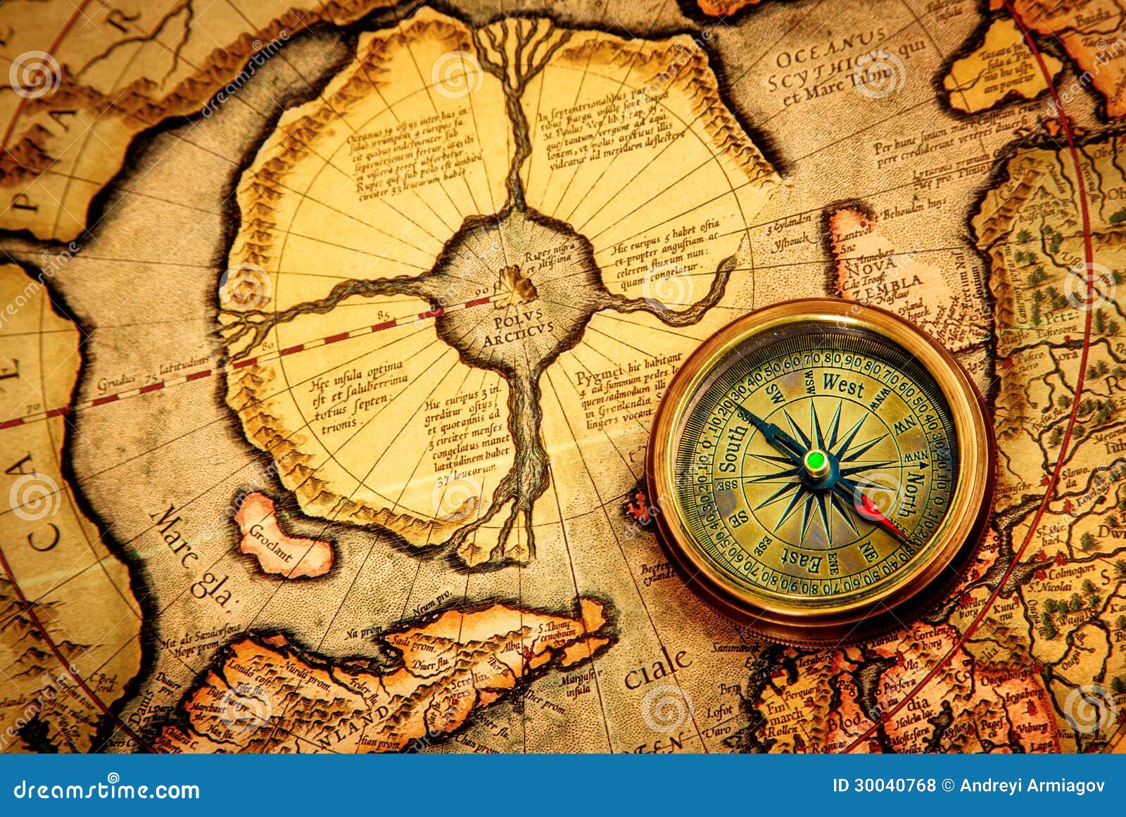 Vintage Compass Lies on an Ancient Map of the North Pole. Stock Photo