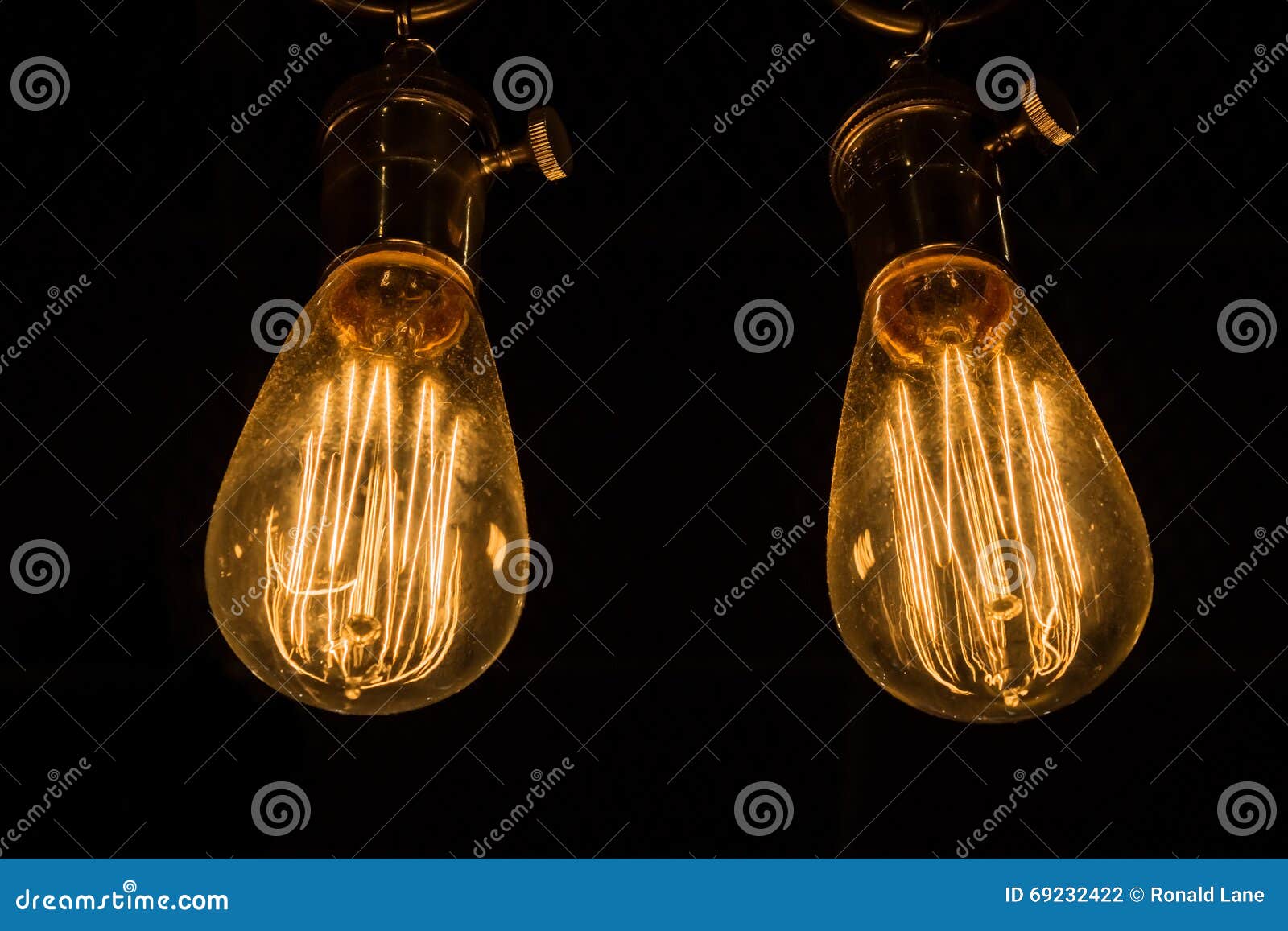 Vintage Edison Light Bulbs Hanging Against A Black Background Stock