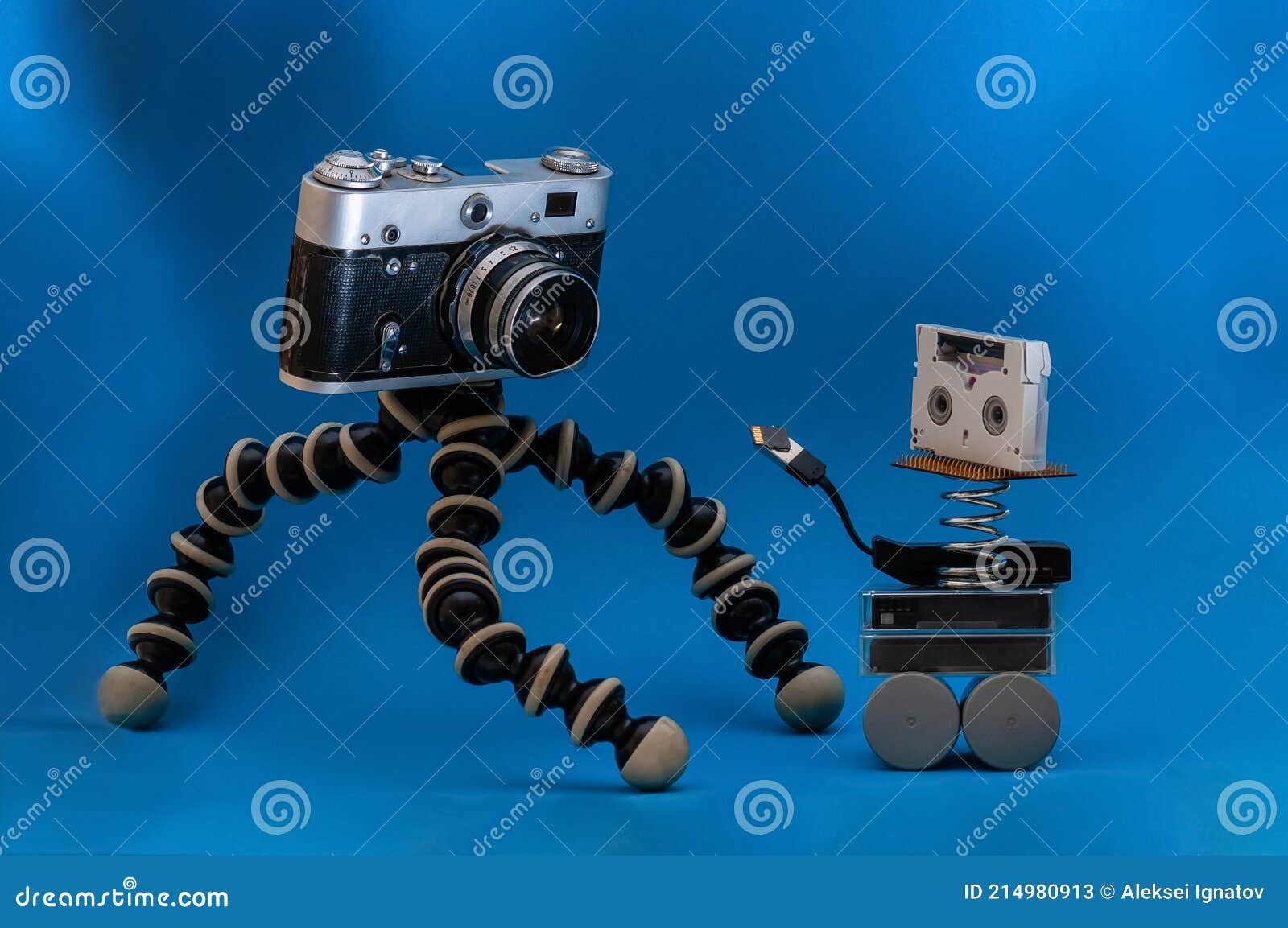 Vintage Film Camera and Video Cassettes on a Blue Background. Card