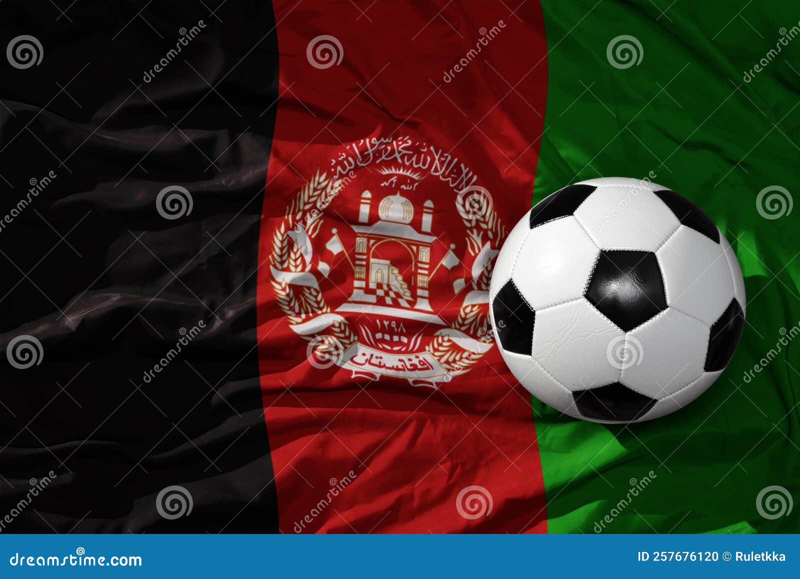 vintage football ball on the waveing national flag of afghanistan background. 3d 