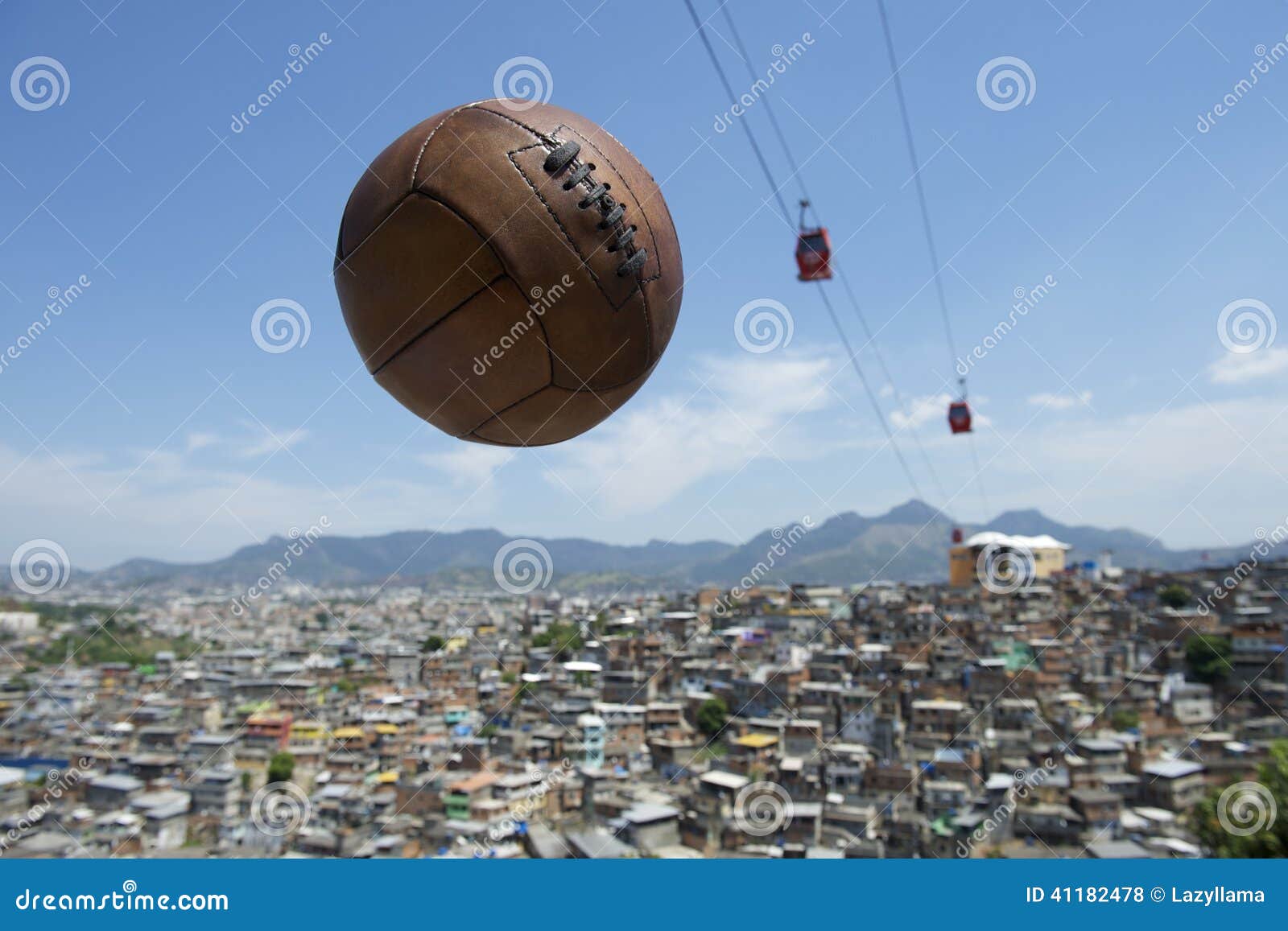 Vintage Football Soccer Ball Rio de Janeiro Brazil Favela. Vintage brown football soccer ball flying in the sky with red cable cars above Rio de Janeiro Brazil favela Complexo Alemao