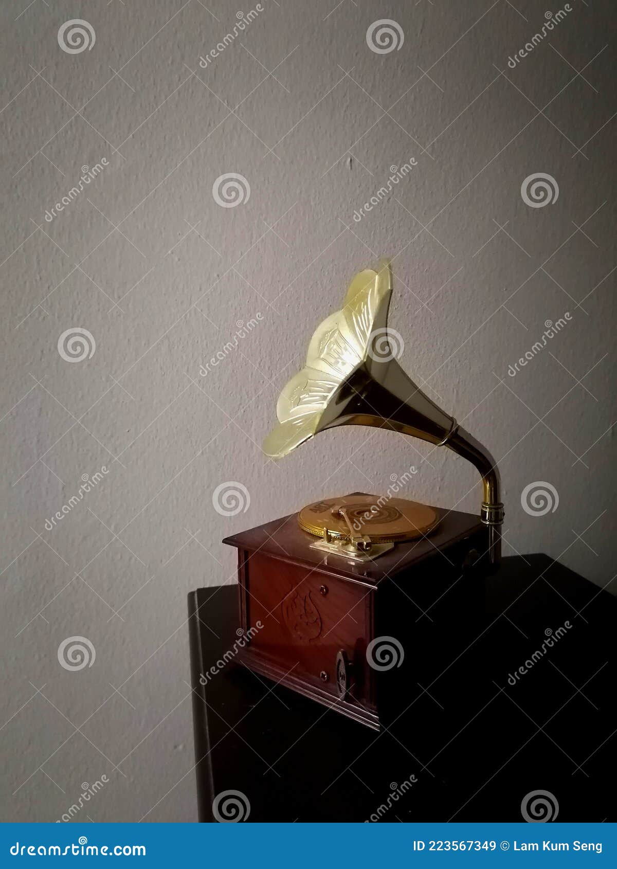 Vintage Gramophone Music Box on a Wooden Table with Dramatic Lighting