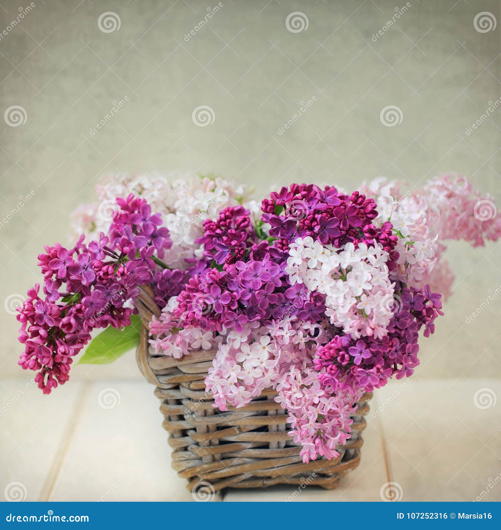 vintage lilac flowers bouquet in wisker basket