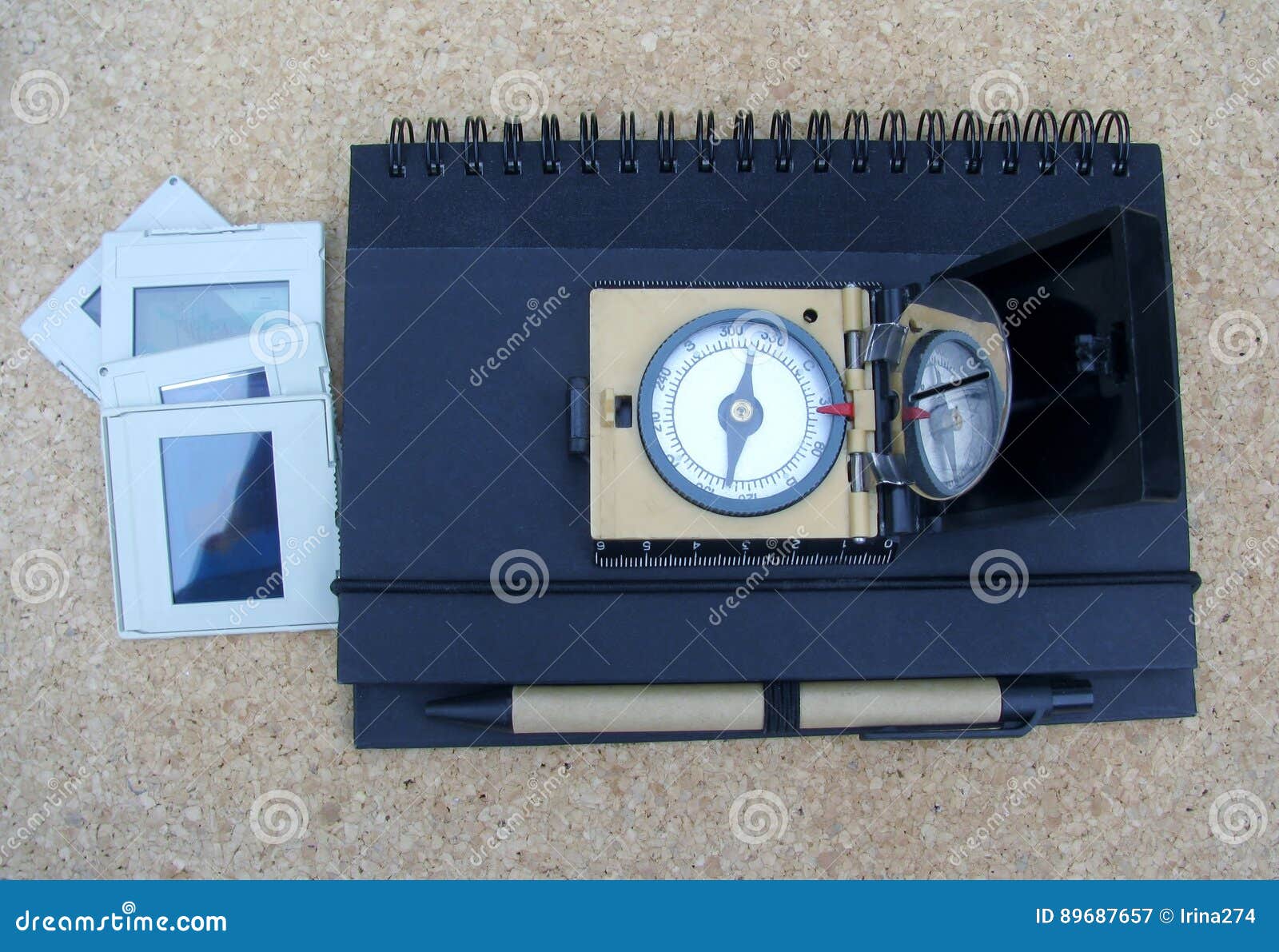 vintage magnetic compass, slides, a notepad with a pen